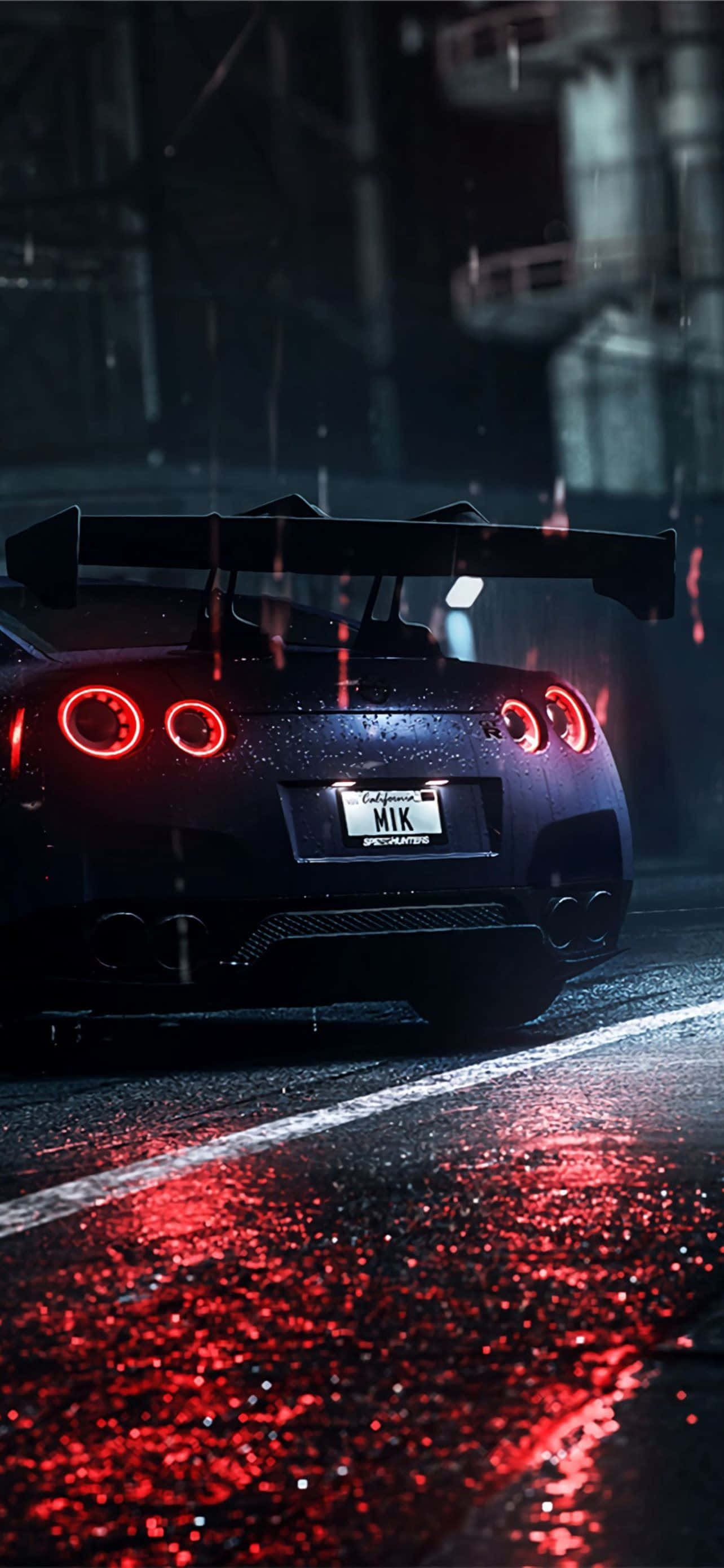 日產Skyline：精緻且科技感十足的轎車 壁紙 — 一輛黑色跑車亮著紅色尾燈，在夜間雨中行駛在濕漉漉的城市街道上。