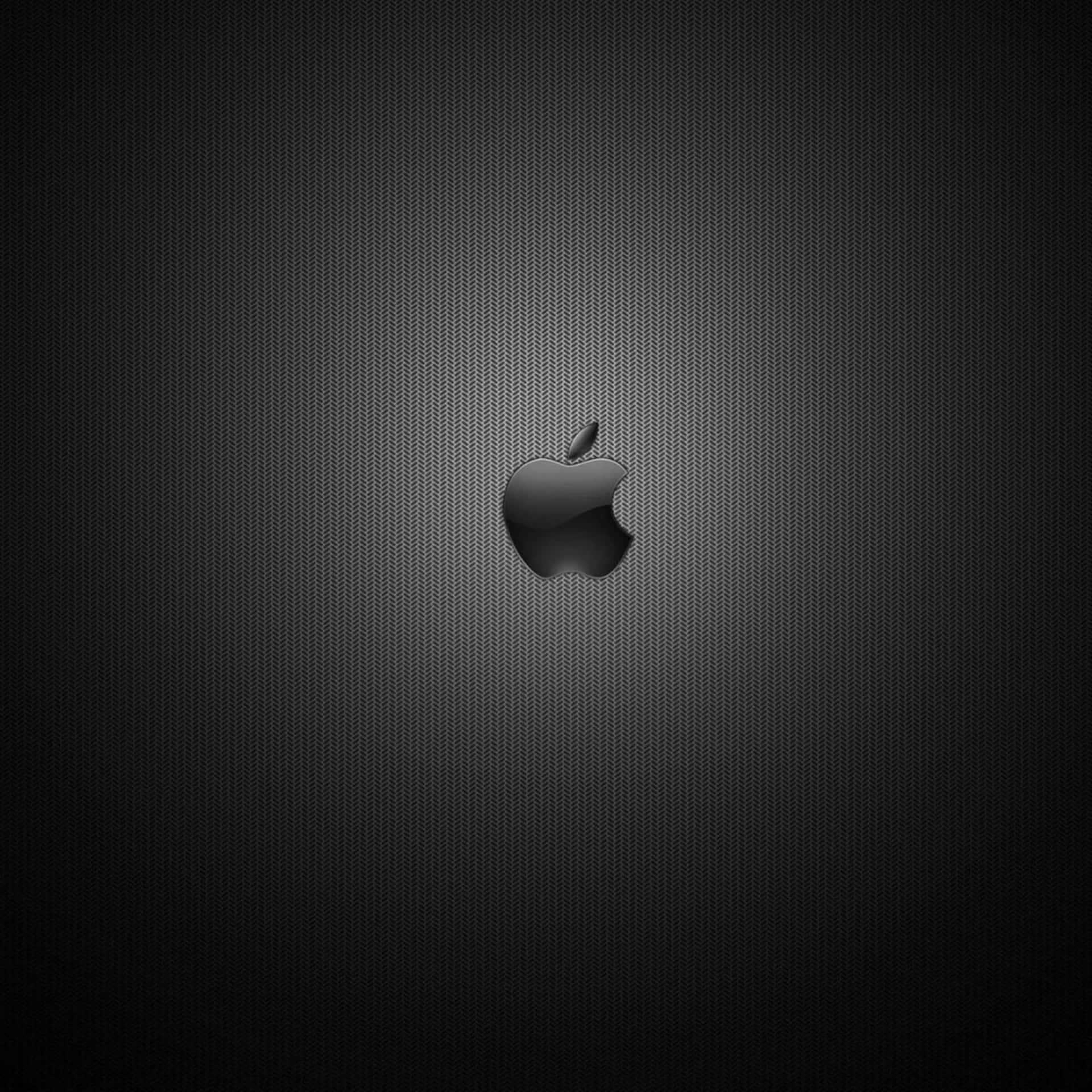 黑色Apple標誌在深色紋理背景上，帶有漸變照明。 — iPad 壁紙