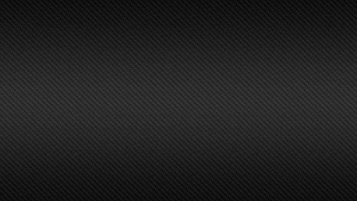 黑色碳纖維紋理，帶有斜紋編織和漸變照明。 — 4K 壁紙