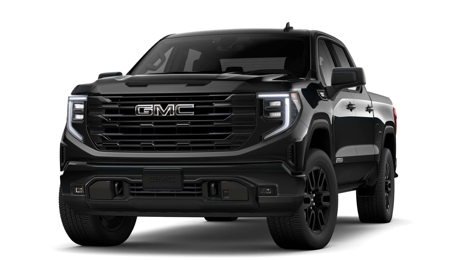 Gmc Sierra 桌布 壁紙 — 一輛時尚的黑色GMC Sierra皮卡車，在工作室燈光下展示，線條銳利，配備現代LED頭燈。