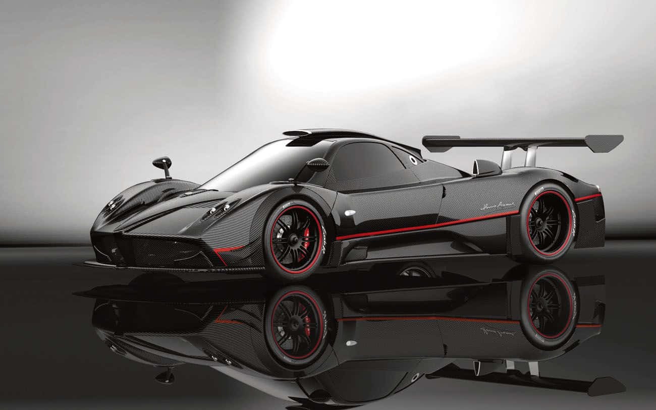 Pagani Zonda C12 Roadster 桌布 壁紙 — 一輛帶有紅色點綴的時尚黑色Pagani超跑在攝影棚燈光下閃耀，完美倒映在光澤地板上。