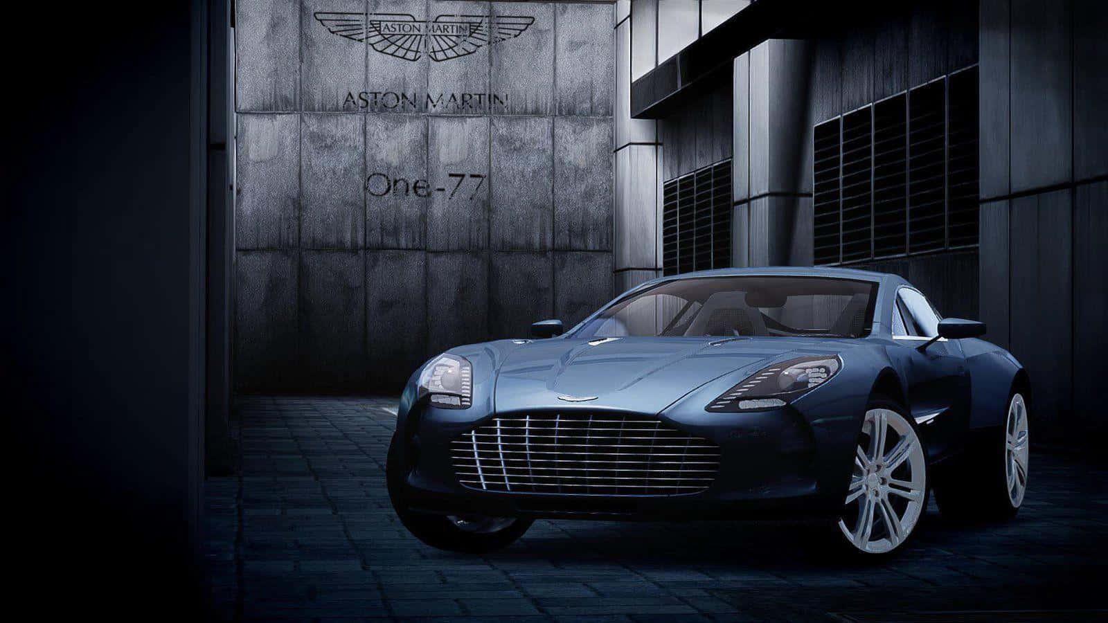 Aston Martin One-77 桌布 壁紙 — 一輛時尚的藍色Aston Martin One-77跑車在現代工業車庫的戲劇性燈光下閃閃發光。