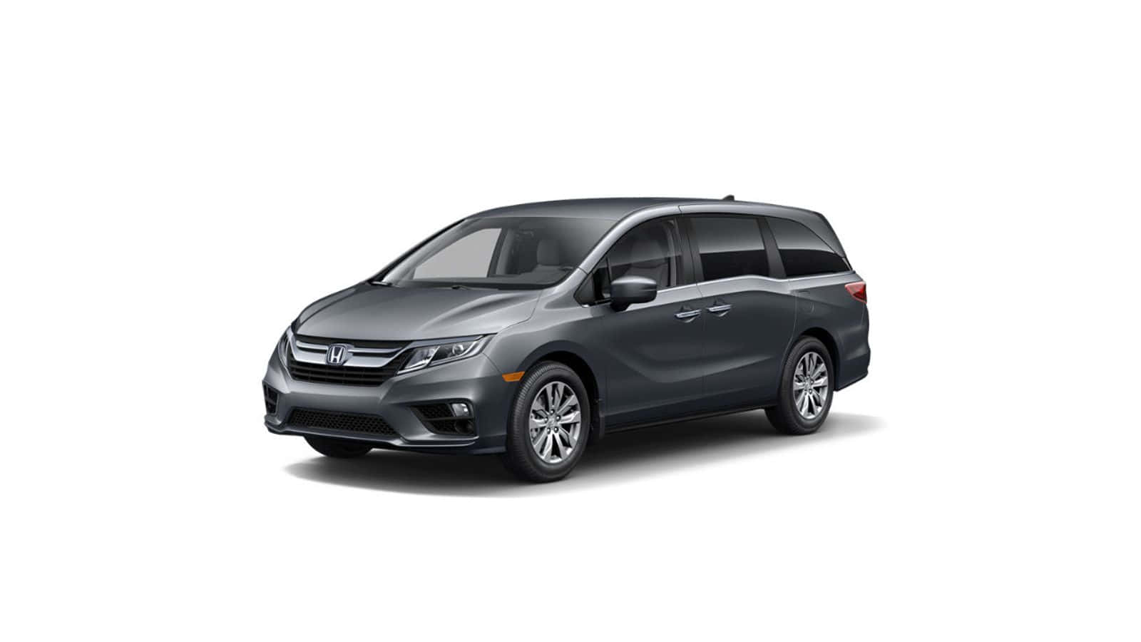 Honda Odyssey 桌布 壁紙 — 在工作室燈光下，一輛時尚的深灰色本田奧德賽小型貨車展示在乾淨的白色背景上。