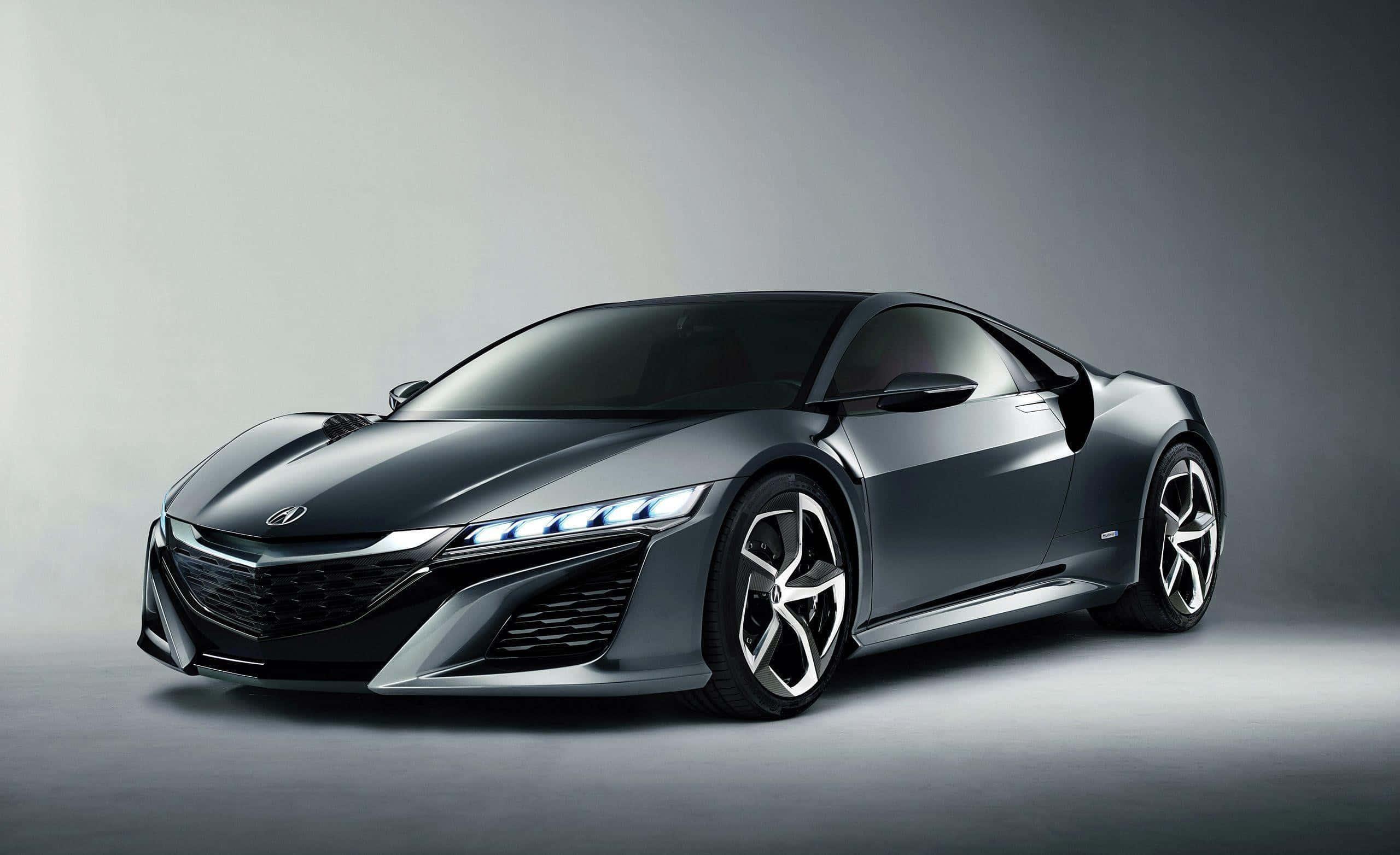 Acura Nsx 桌布 壁紙 — 一輛時尚的啞光灰色跑車配以發光頭燈，在簡約的工作室環境中展示。