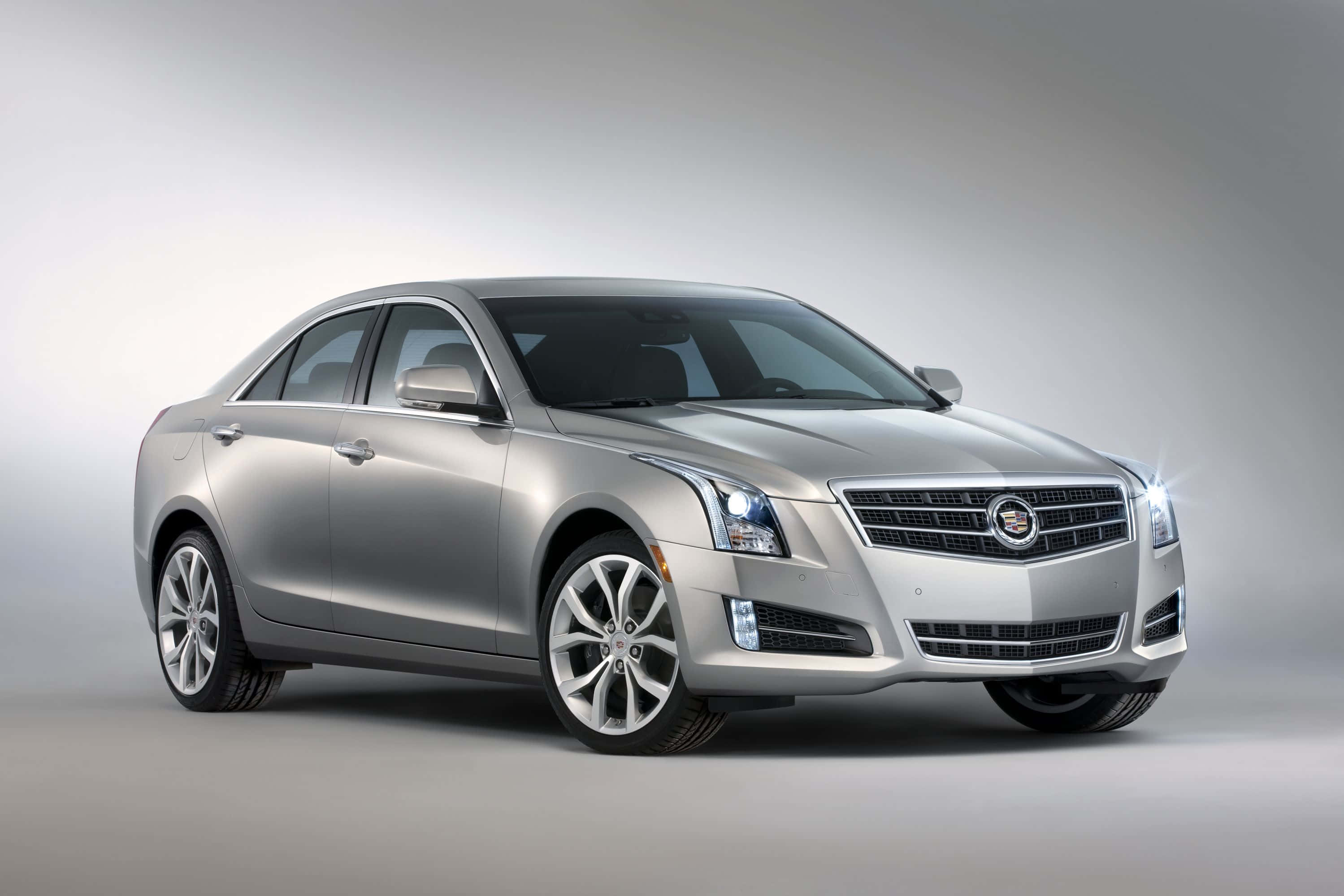 Cadillac Xts 桌布 壁紙 — 一輛時尚的銀色Cadillac ATS轎車在工作室燈光下閃耀，線條銳利，合金輪圈拋光。