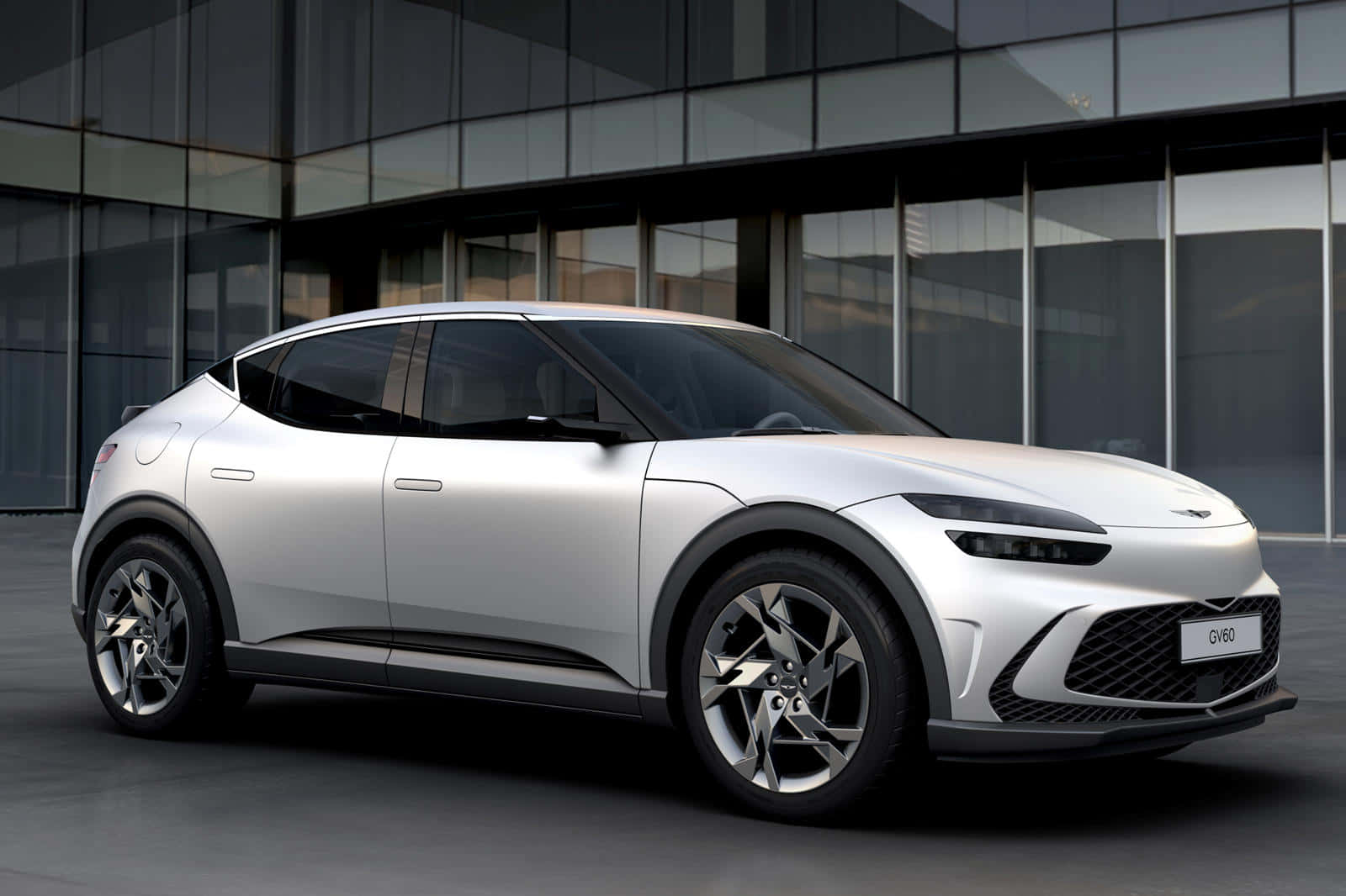 銀色電動SUV停在一棟現代玻璃建築前。 — Toyota Supra Mk4 壁紙