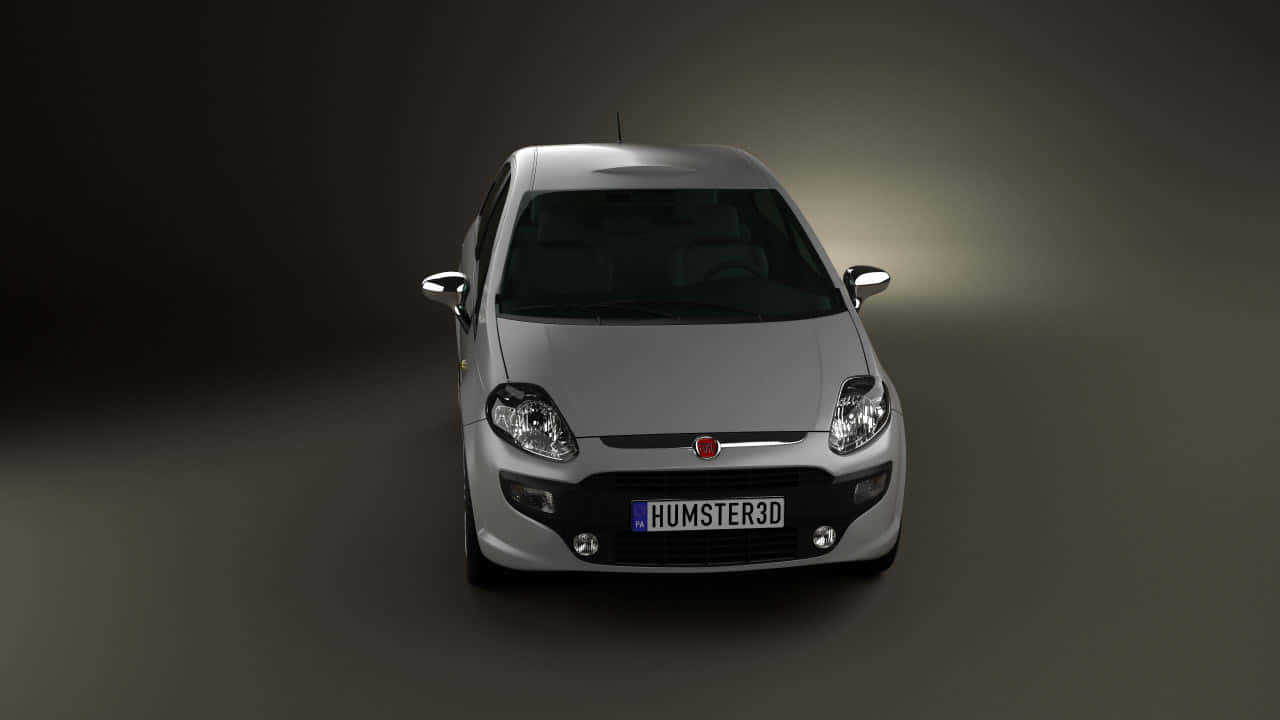 Fiat Punto 桌布 壁紙 — 一架時尚的銀色 Fiat Punto 位於昏暗的攝影棚中央，戲劇性的聚光燈凸顯其前格柵和頭燈。