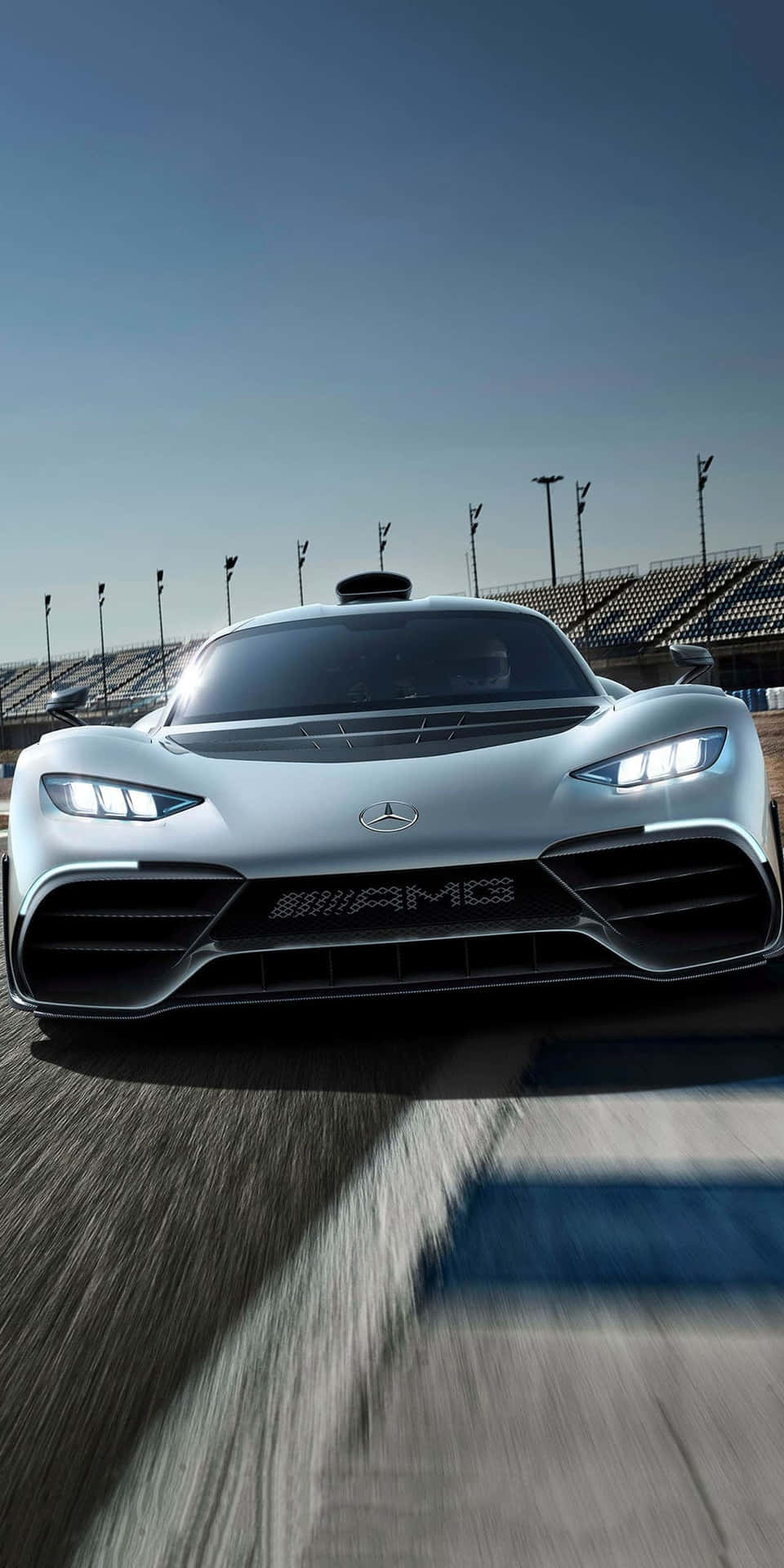 銀色 Mercedes-AMG 賽車在賽道上疾馳，帶有動態模糊效果。 — Project Cars 壁紙