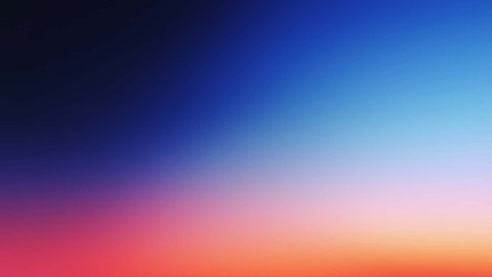 壁紙 — 平滑漸層的天空，從深藍色過渡到充滿活力的橙色和粉紅色調。