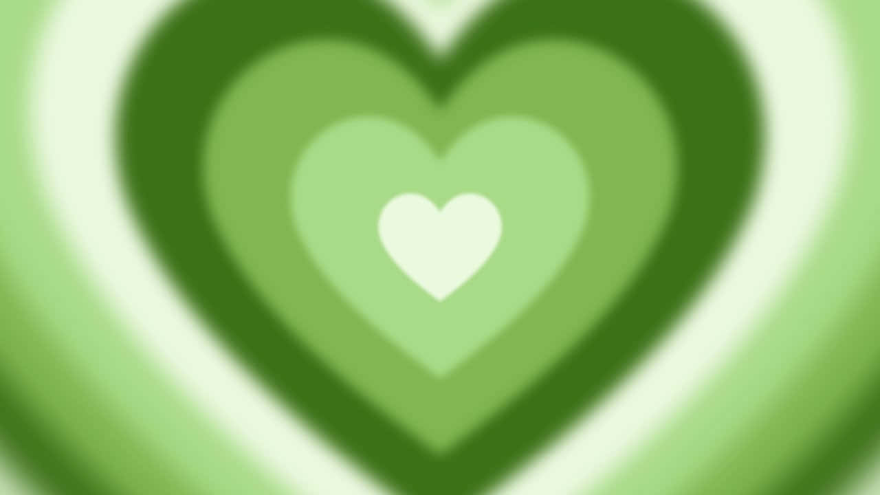  壁紙 — 一個柔和焦點的抽象圖案，由各種綠色調的同心心形從明亮的白色中心向外輻射而成。