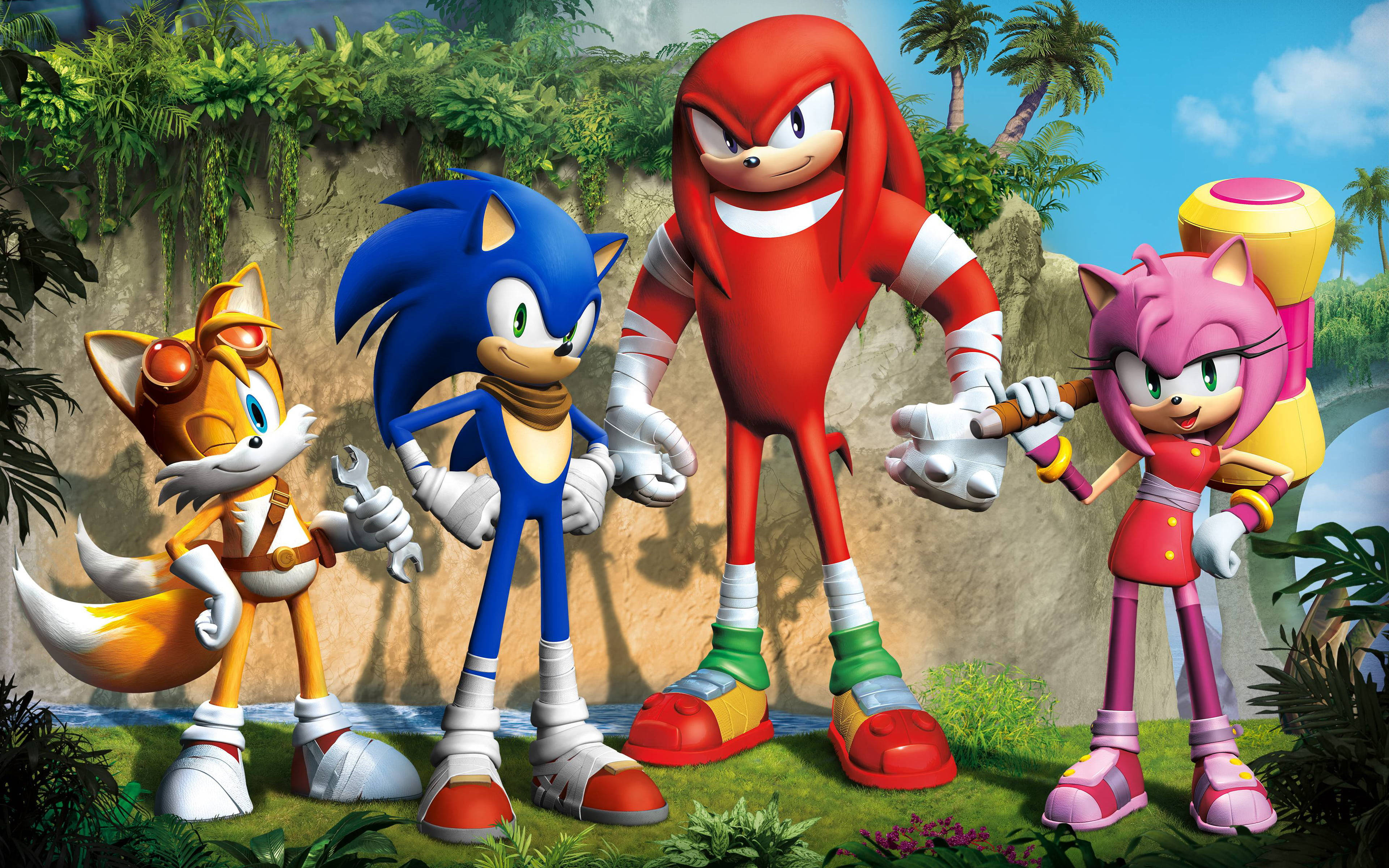 電玩遊戲 桌布 壁紙 — Sonic、Knuckles、Amy 和 Tails 一起站在茂密的叢林中，背景有棕櫚樹和岩石峭壁。