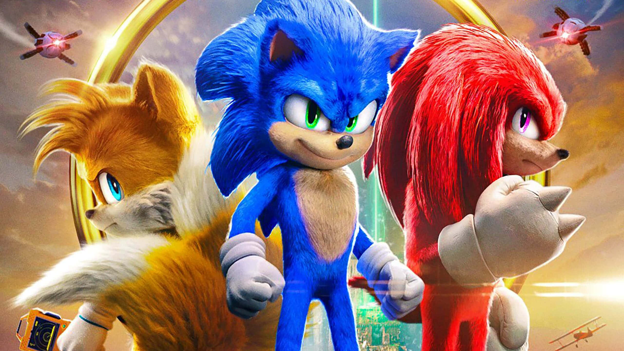 音速小子 桌布 壁紙 — Sonic、Knuckles 和 Tails 在金色環形背景下英勇站立，伴隨著飛行車輛和發光的城市景觀。