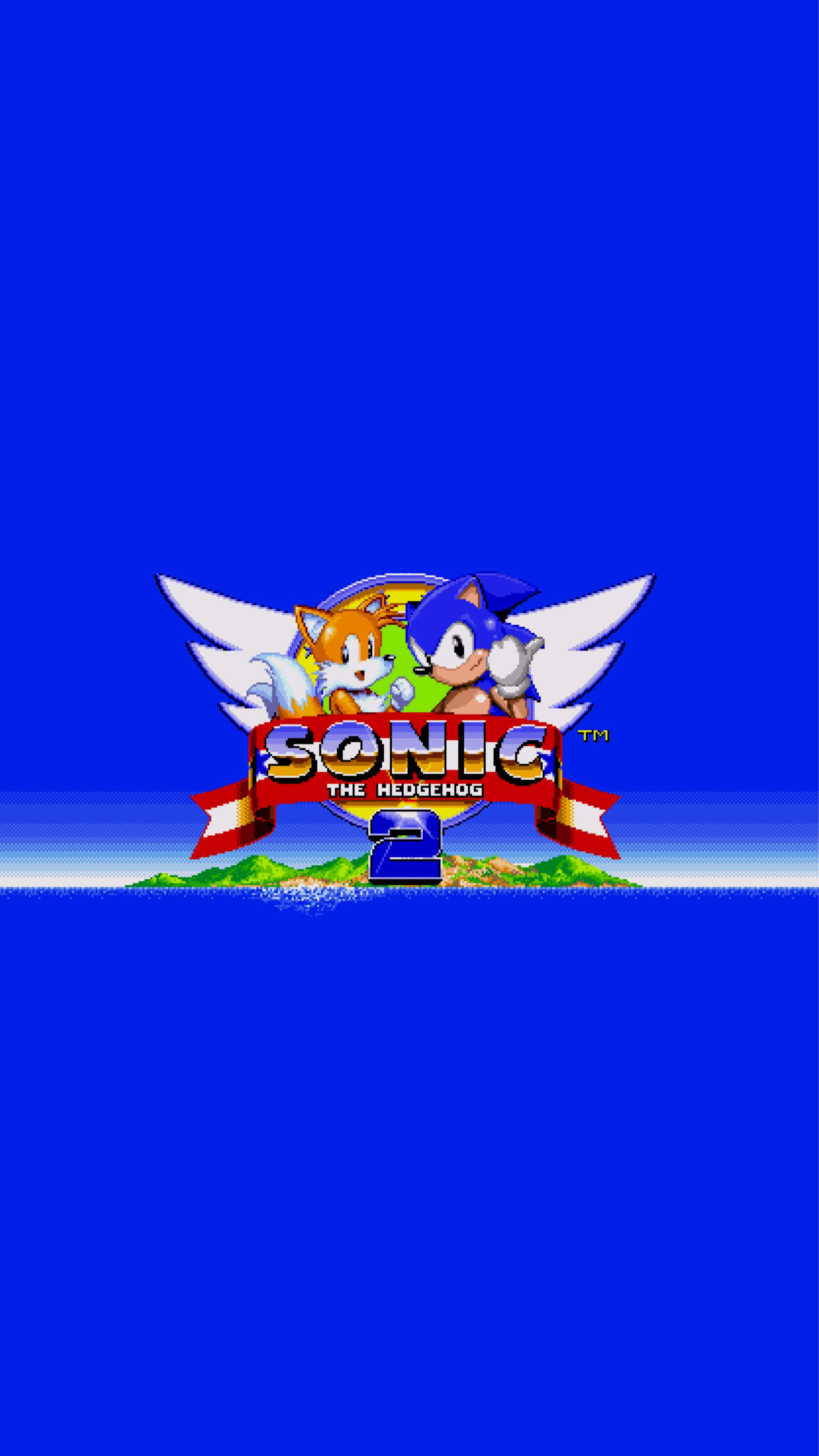 Sonic 2 桌布 壁紙 — Sonic the Hedgehog 和 Tails 有翅膀飛在紅色橫幅上方，橫幅寫著 Sonic the Hedgehog 2，背景是純藍色。