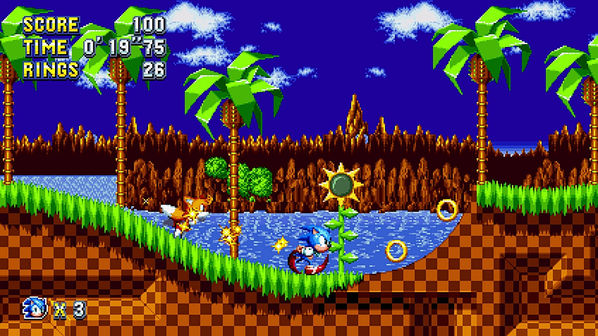 電玩遊戲 桌布 壁紙 — Sonic the Hedgehog 在藍天下，穿過一個有棕櫚樹和金環的像素化熱帶河流。