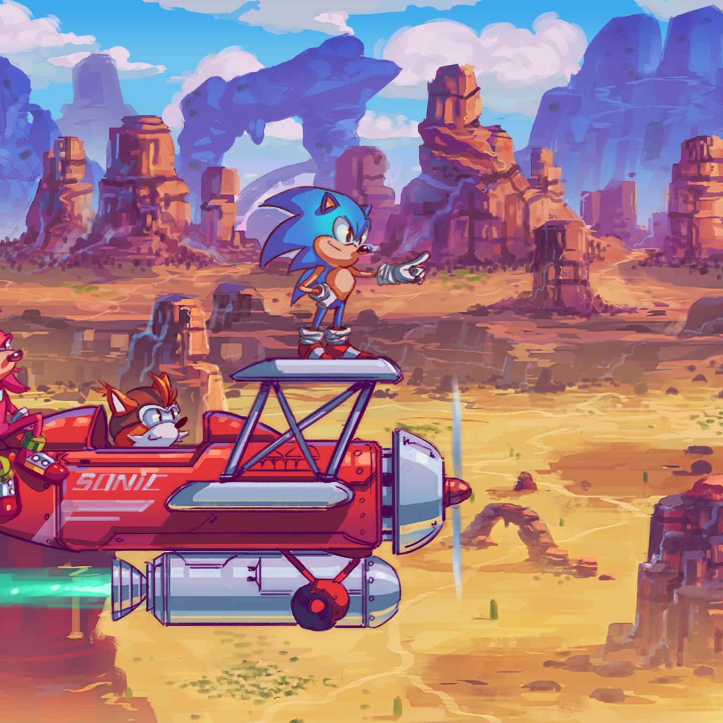 Tails 桌布 壁紙 — Sonic the Hedgehog 站在一架紅色飛機上，飛過一個有岩石地貌的沙漠峽谷，下方是晴朗的藍天。