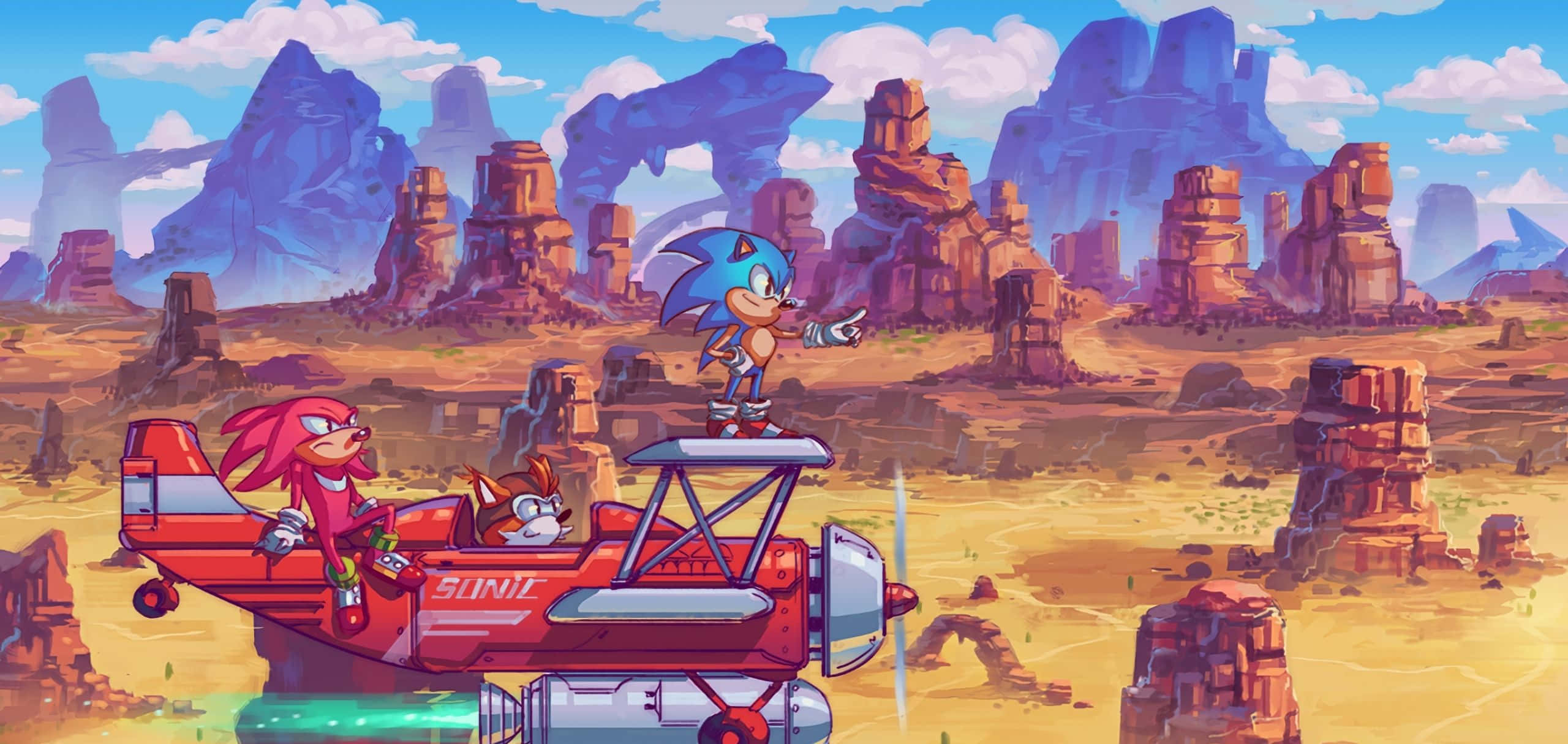 Sonic Angel Island 桌布 壁紙 — Sonic the Hedgehog 站在一架由 Knuckles 和 Tails 駕駛的紅色飛機上，飛過一個有岩石形成的沙漠峽谷。