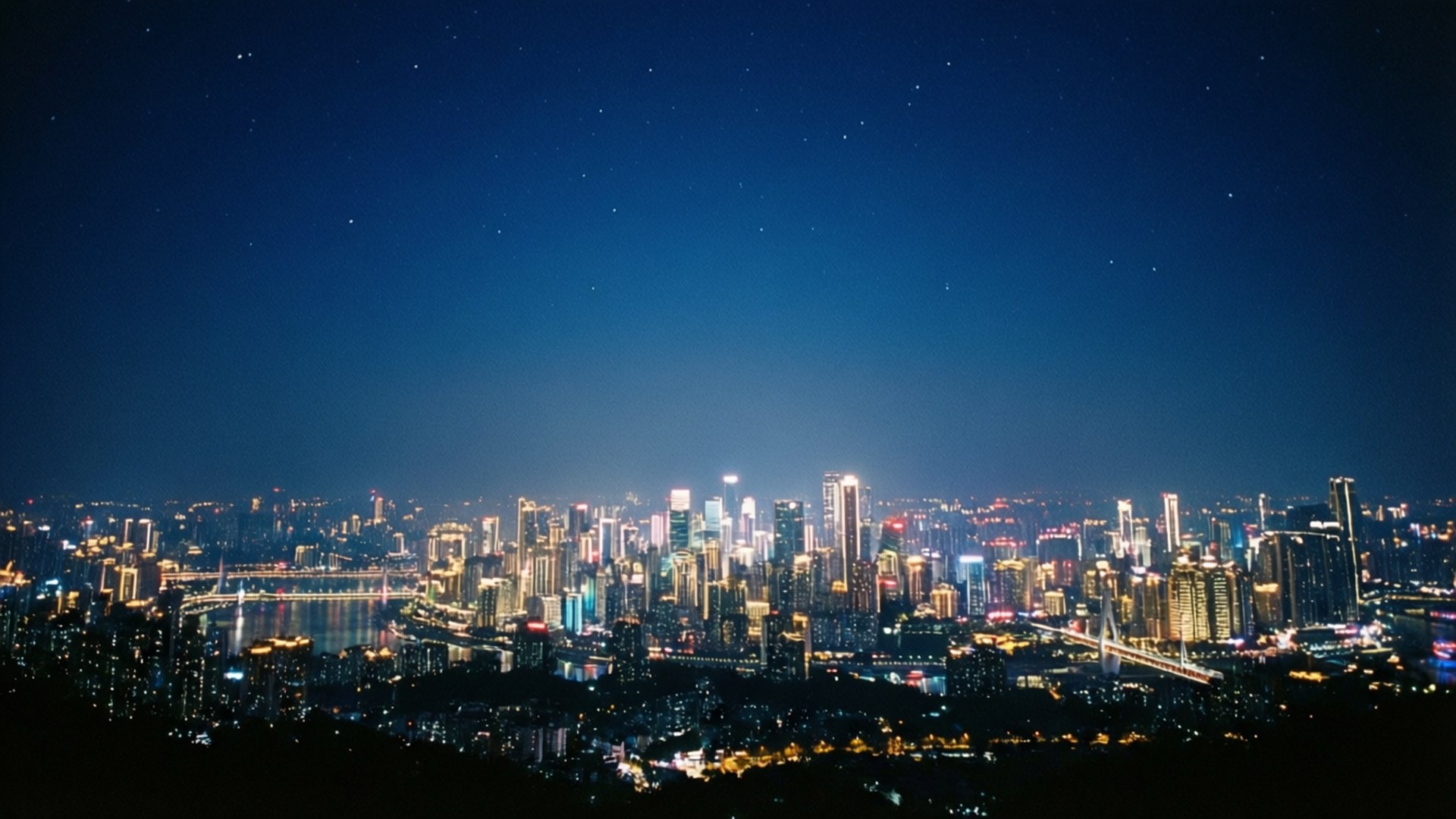 City of Stars 壁紙 — 廣闊的夜景城市景觀，閃爍的摩天大樓和橋樑在繁星點點的深藍色天空下。