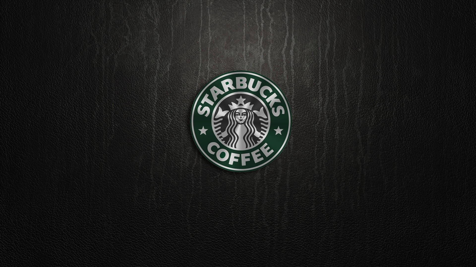 星巴克 桌布 壁紙 — Starbucks咖啡標誌居中放置在深色紋理皮革背景上，帶有柔和燈光。