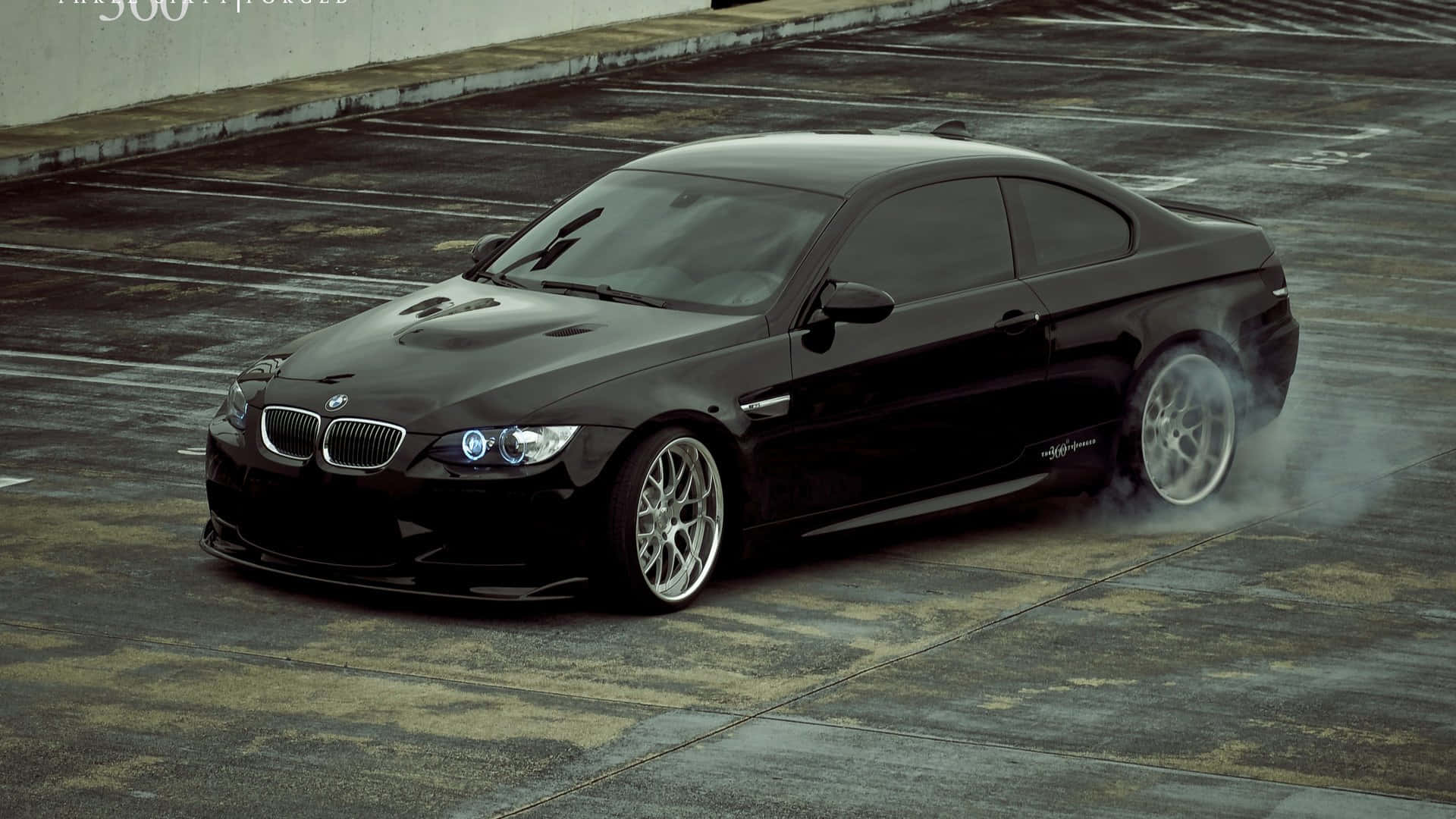 黑色BMW M3在濕滑混凝土上甩尾冒煙。 — 飄移賽車 壁紙