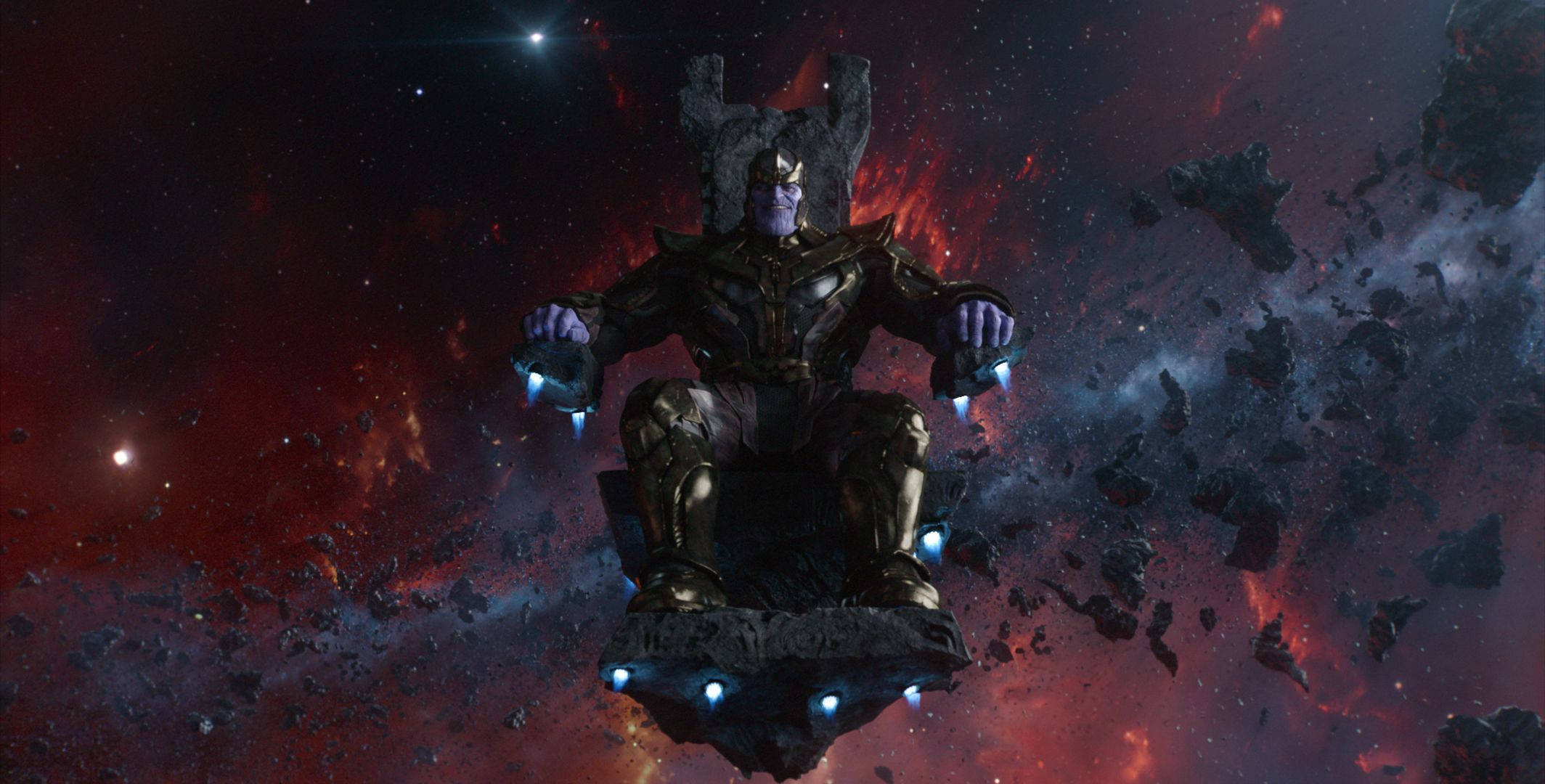 薩諾斯 桌布 壁紙 — Thanos 威嚴地坐在一個漂浮的王座上，身處一個帶有發光藍色點綴的熾熱宇宙星雲中。