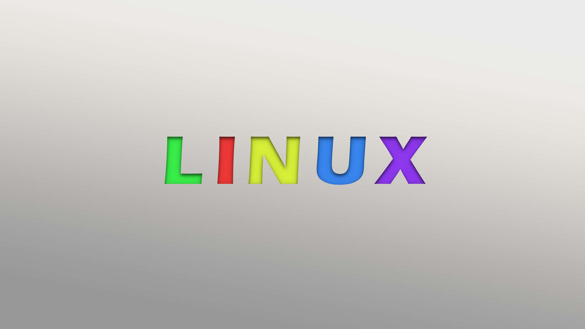 灰色漸變背景上的彩虹色 Linux 文字。 — Linux 壁紙