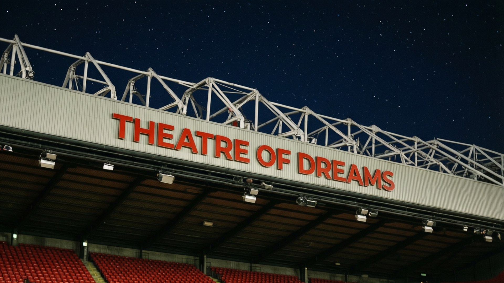 Theatre of Dreams 壁紙 — Theatre of Dreams 標誌在球場座位上方繁星點點的夜空下發出紅光。