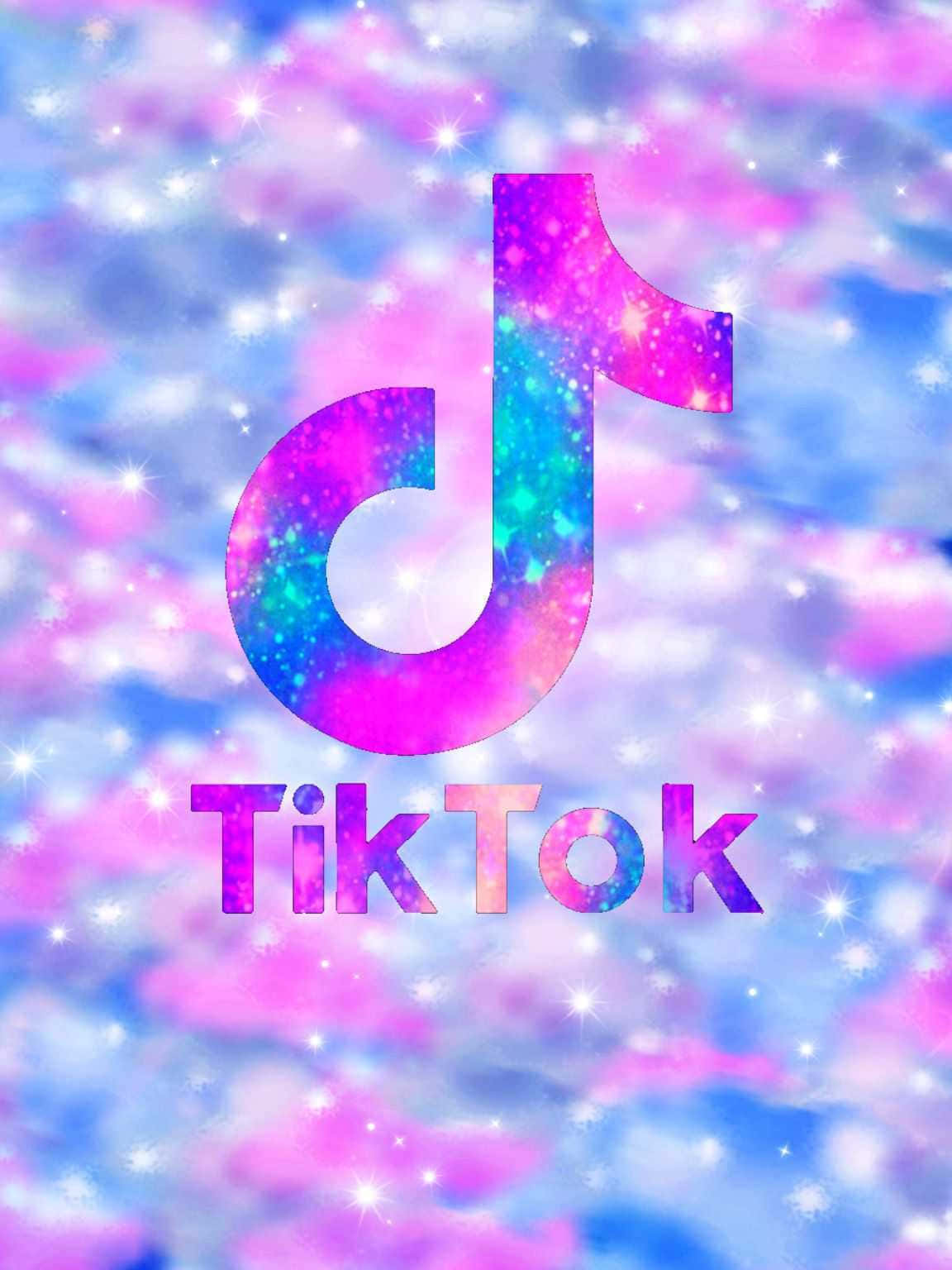 TikTok 動圖 桌布 壁紙 — TikTok 標誌在夢幻宇宙背景下閃爍著粉紅色和藍色的閃光。