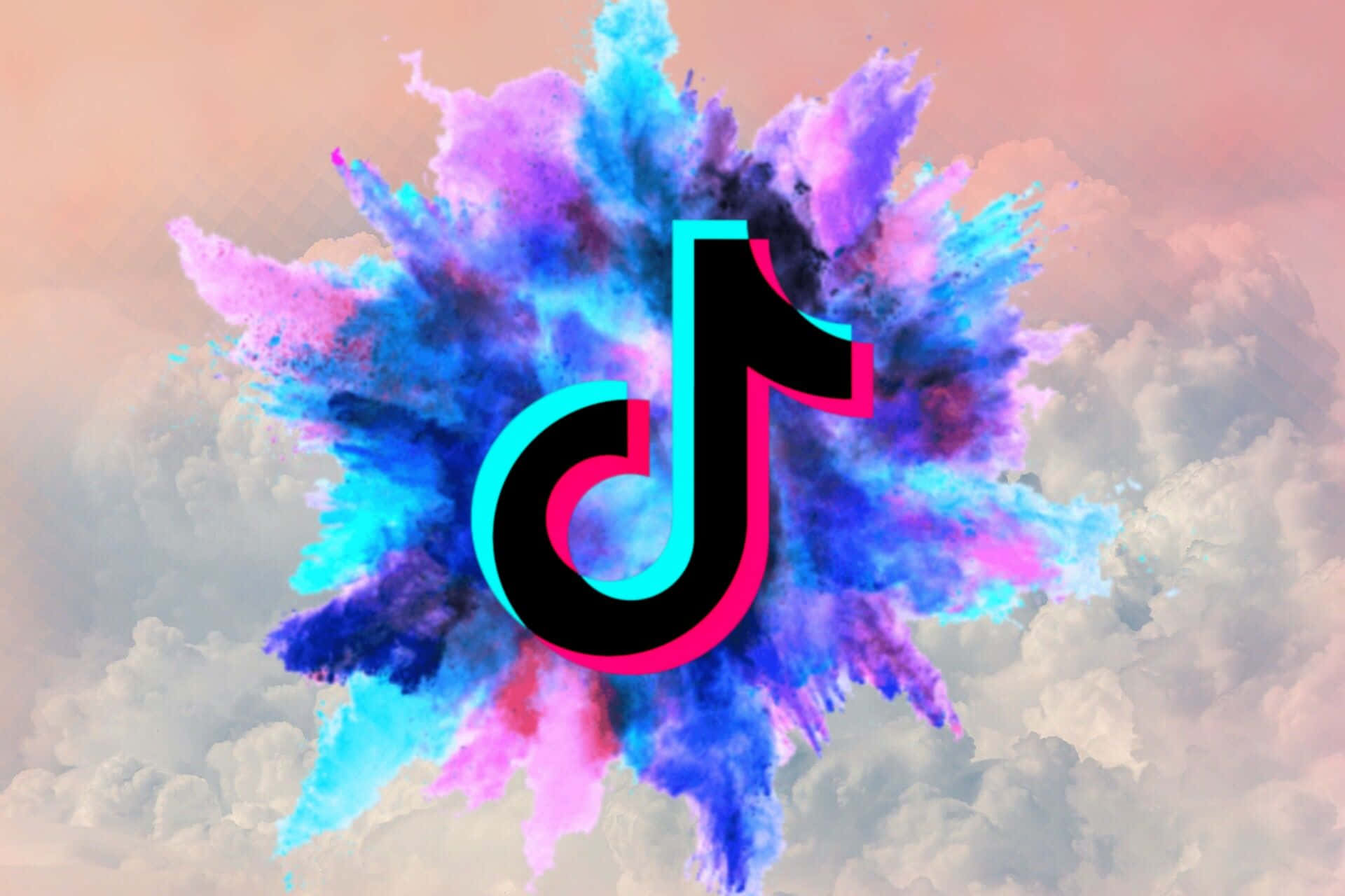 TikTok 動圖 桌布 壁紙 — TikTok 標誌從充滿活力的藍色和粉紅色粉末爆炸中浮現，背景是柔和的粉彩天空和蓬鬆的雲朵。