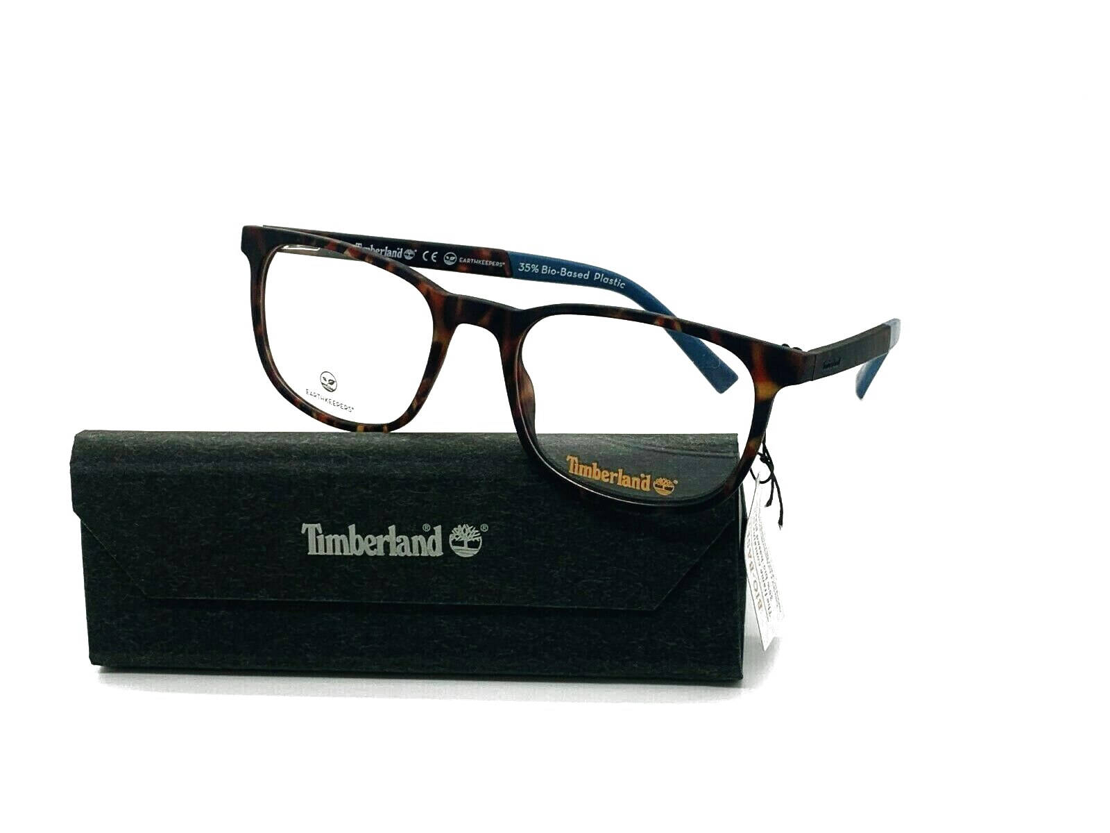 品牌 桌布 壁紙 — Timberland 眼鏡，龜甲框和藍色鏡腿尖端，放置在帶紋理的黑色眼鏡盒上，背景為純白色。