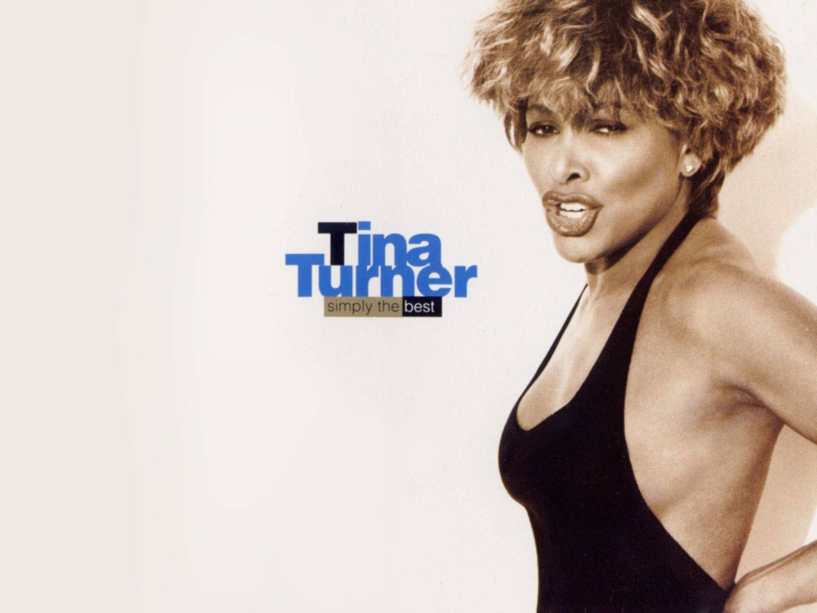 icon 桌布 壁紙 — Tina Turner 自信地擺姿勢，身穿黑色掛頸上衣，背景簡潔，顯示了她的名字和專輯名稱。