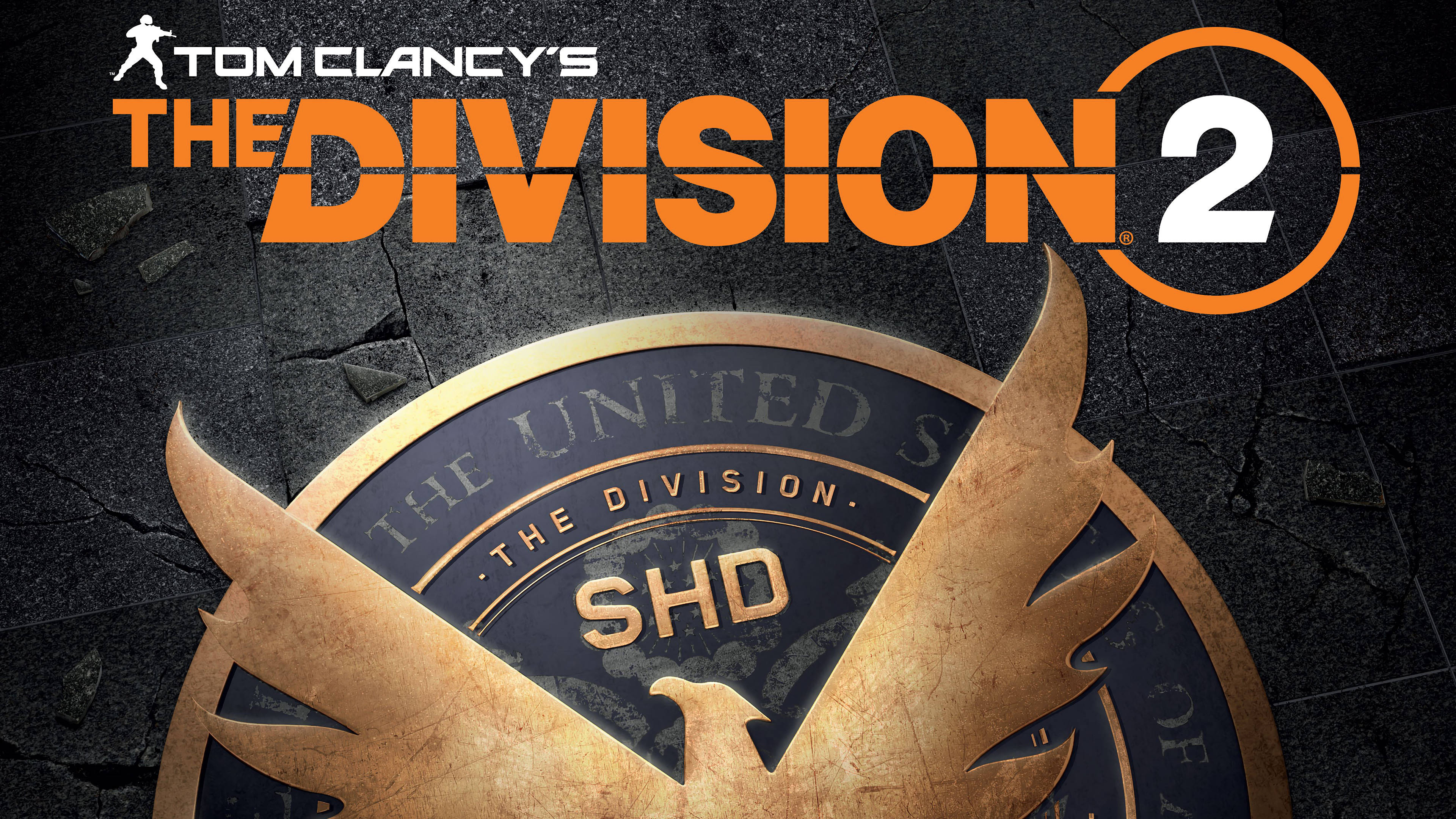 電玩遊戲 桌布 壁紙 — Tom Clancy's The Division 2 標誌，金色SHD徽章在裂開的深色石頭背景上。