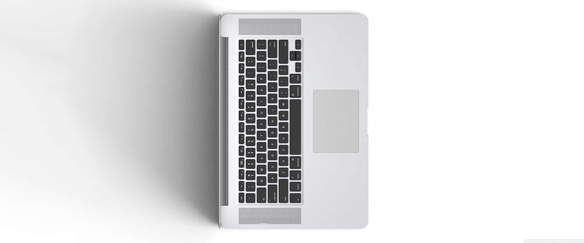 從上方觀看白色表面上的銀色筆記型電腦鍵盤和觸控板。 — Macbook Pro 壁紙