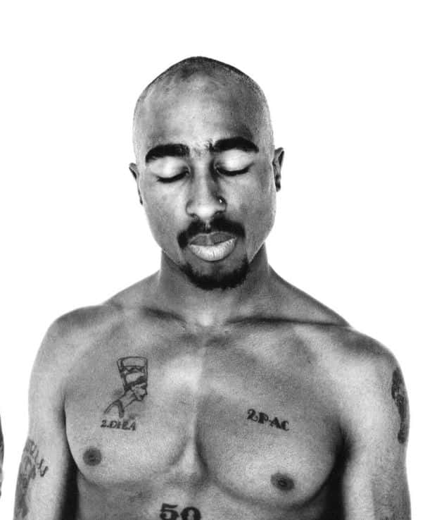tupac 桌布 壁紙 — Tupac Shakur 的黑白肖像，雙眼閉合，胸口和手臂上的刺青清晰可見。