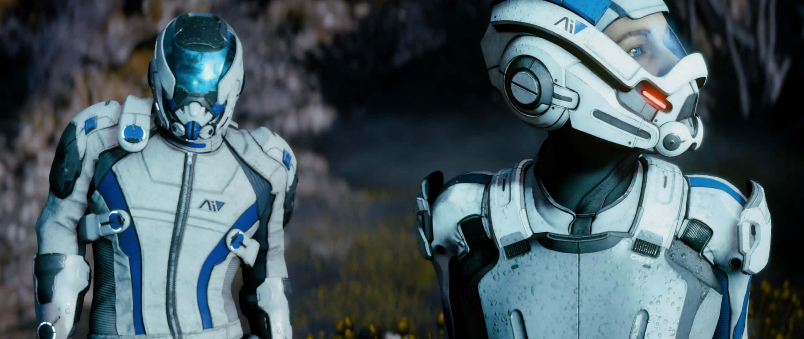 Mass Effect Andromeda 桌布 壁紙 — 兩名身穿白色和藍色盔甲的未來太空人在昏暗燈光下並肩站在岩石外星景觀中。