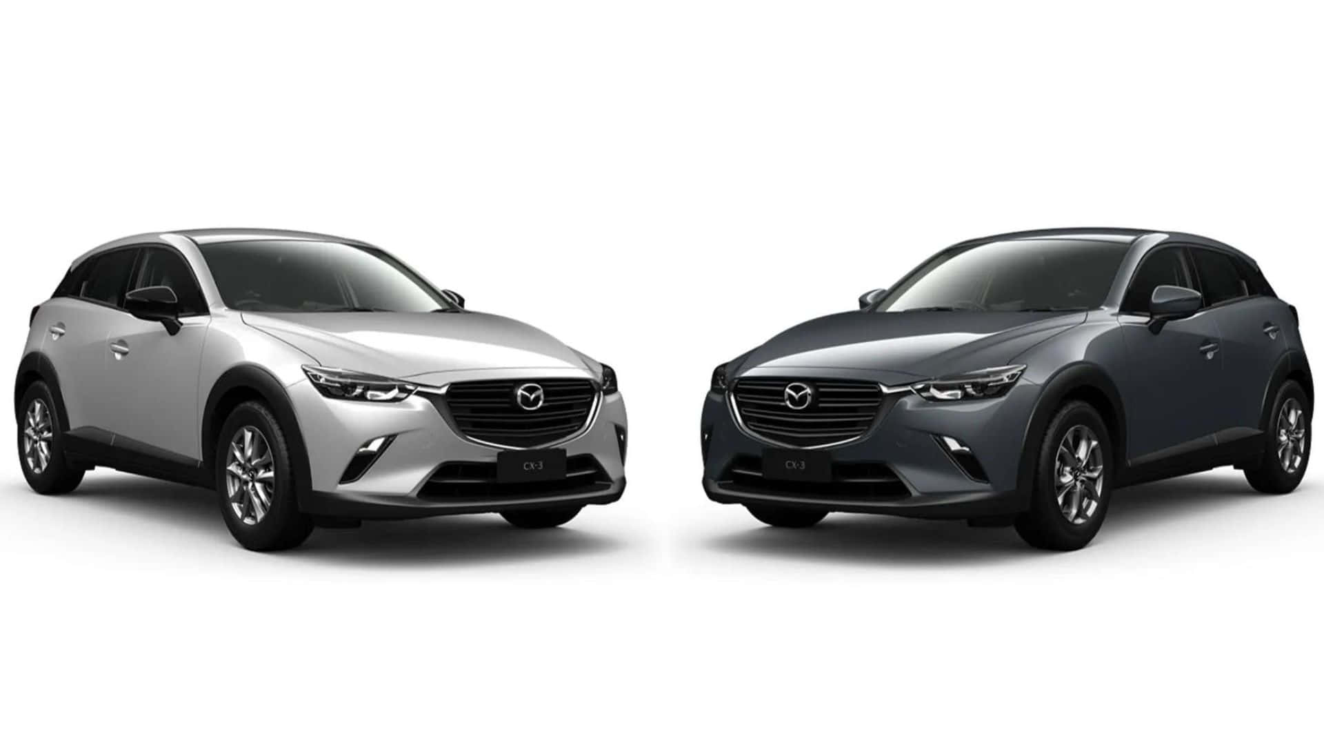 Mazda Cx-3 桌布 壁紙 — 兩款時尚的Mazda CX-3 SUV（銀色和深灰色）並排展示在潔淨的白色工作室背景前。