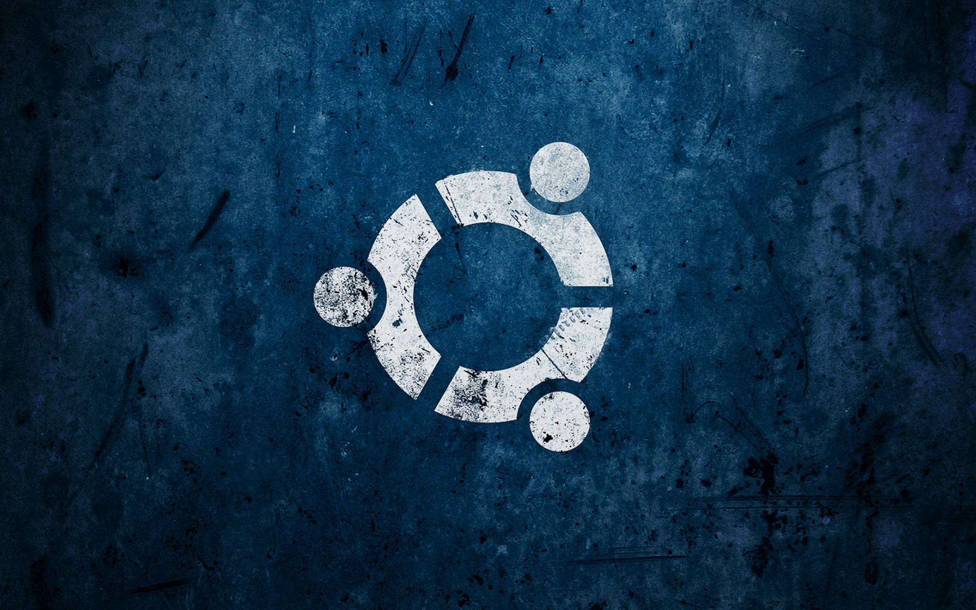 Ubuntu 標誌塗在帶有刮痕和污垢的紋理藍色牆壁上。 — Linux 壁紙