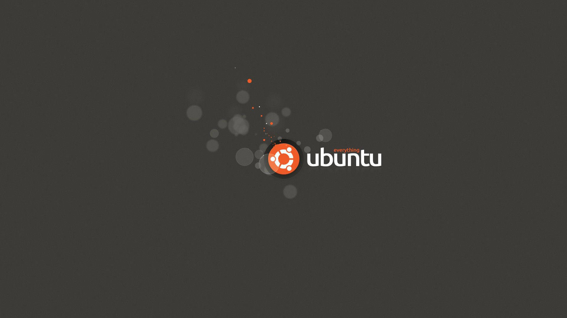 ubuntu 桌布 壁紙 — Ubuntu 標誌，橙色圓圈和白色文字居中，深灰色背景帶有微妙的散景效果。
