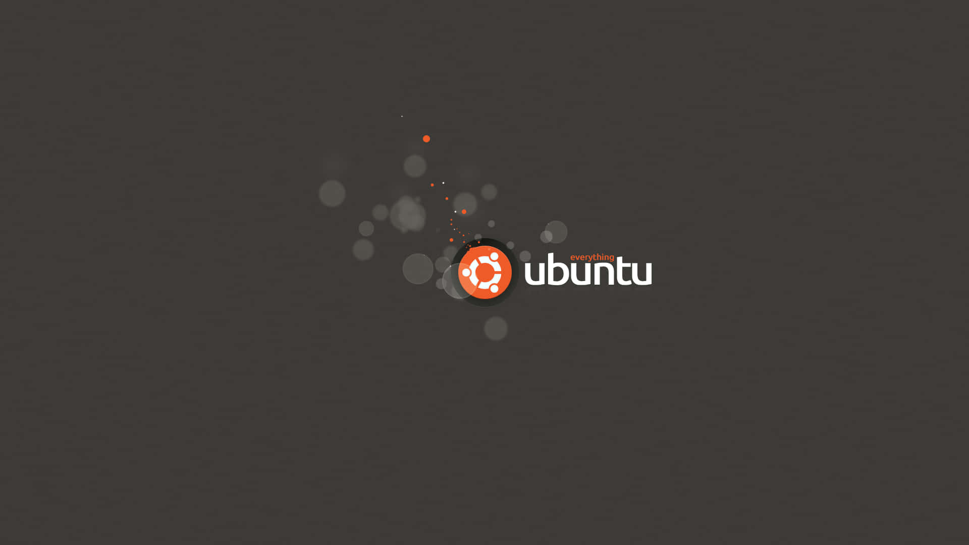 ubuntu 桌布 壁紙 — Ubuntu 標誌，橙色圓圈和白色文字居中在深灰色背景上，帶有浮動的半透明圓圈。