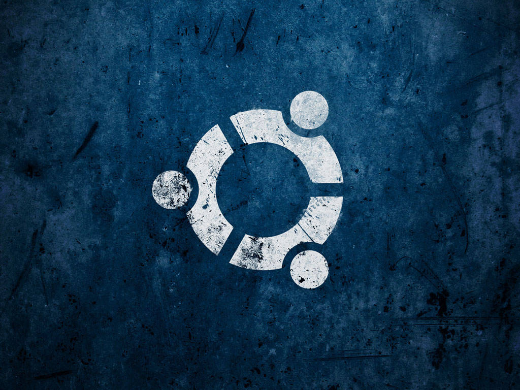 ubuntu 桌布 壁紙 — Ubuntu 標誌以風化白色油漆繪製在帶有刮痕和污垢的紋理深藍色牆壁上。