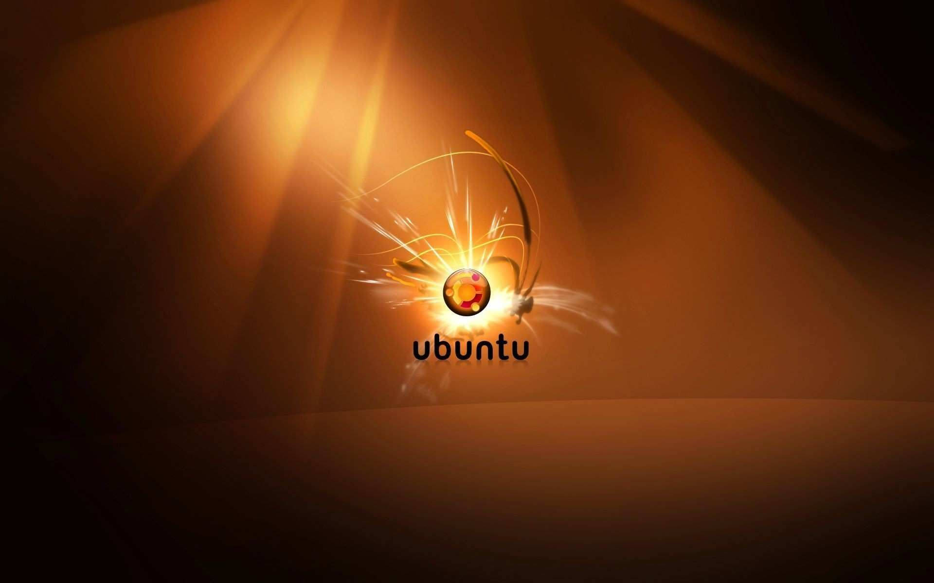 ubuntu 桌布 壁紙 — Ubuntu 標誌在溫暖的漸變背景上散發出金色光芒和動態條紋。