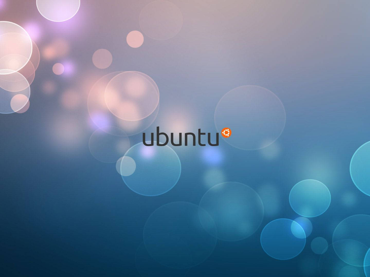 ubuntu 桌布 壁紙 — Ubuntu 標誌居中於柔和的藍色漸變背景上，帶有發光的圓形散景燈光。