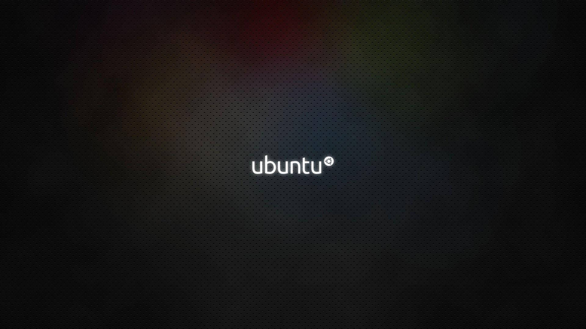 ubuntu 桌布 壁紙 — Ubuntu 標誌置中於深色紋理背景上，帶有微妙的彩虹漸變模糊效果。