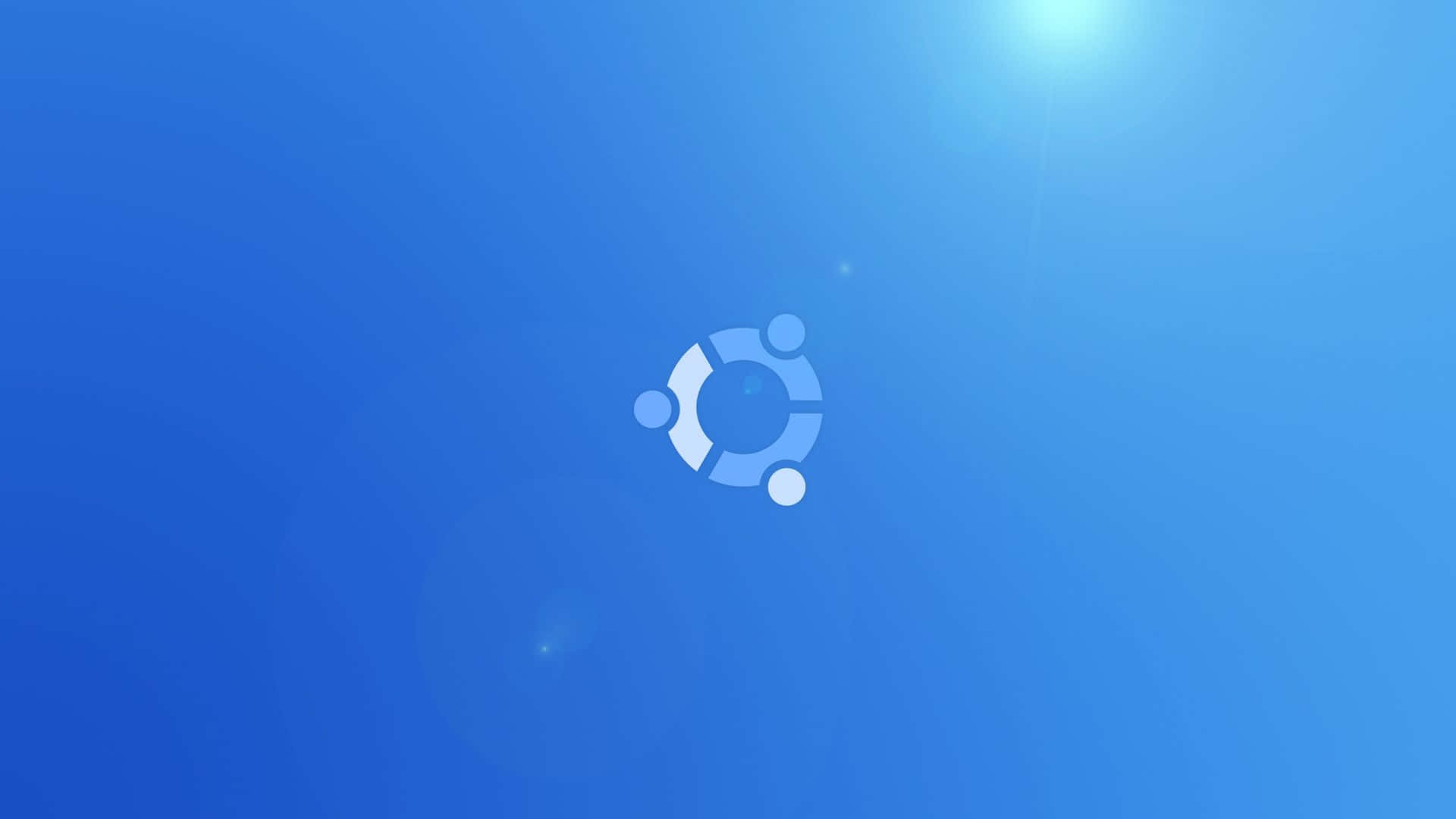 ubuntu 桌布 壁紙 — Ubuntu 標誌置中於漸變藍色背景上，並帶有從右上角射出的鏡頭光暈。