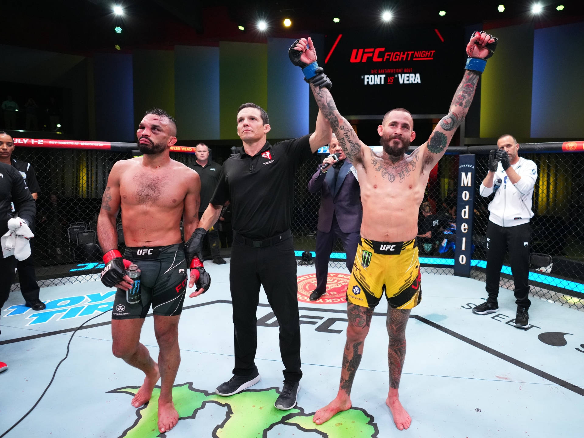 UFC 桌布 壁紙 — UFC拳手在八角籠中高舉雙臂慶祝勝利，裁判舉起他的手。