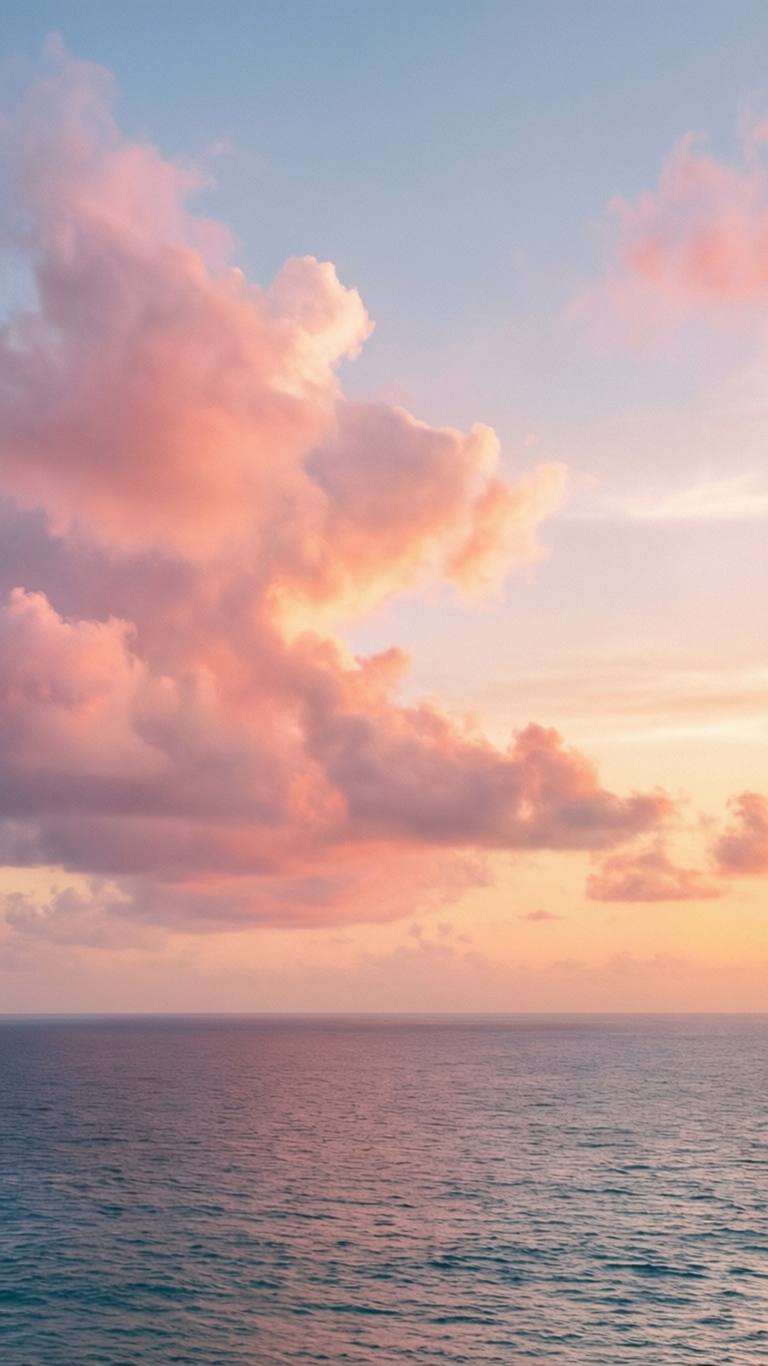 Pastel Sunset Clouds 壁紙 — 廣闊的海洋與天空相遇，在日落時分呈現柔和的粉紅色、橙色和藍色調，蓬鬆的雲朵投下溫柔的陰影。