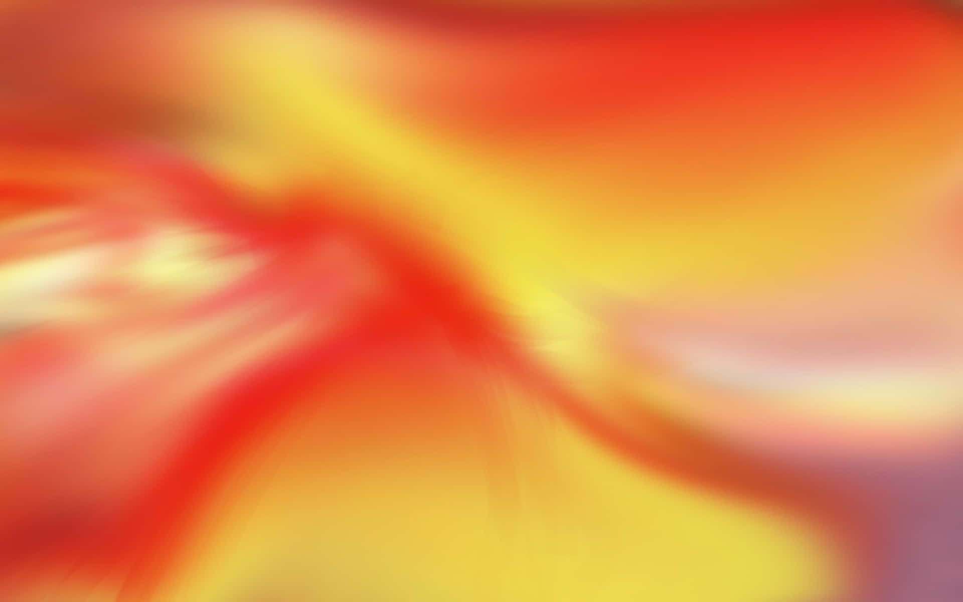  壁紙 — 充滿活力的紅色、橙色和黃色抽象漩渦融合成柔和發光的動態模糊。