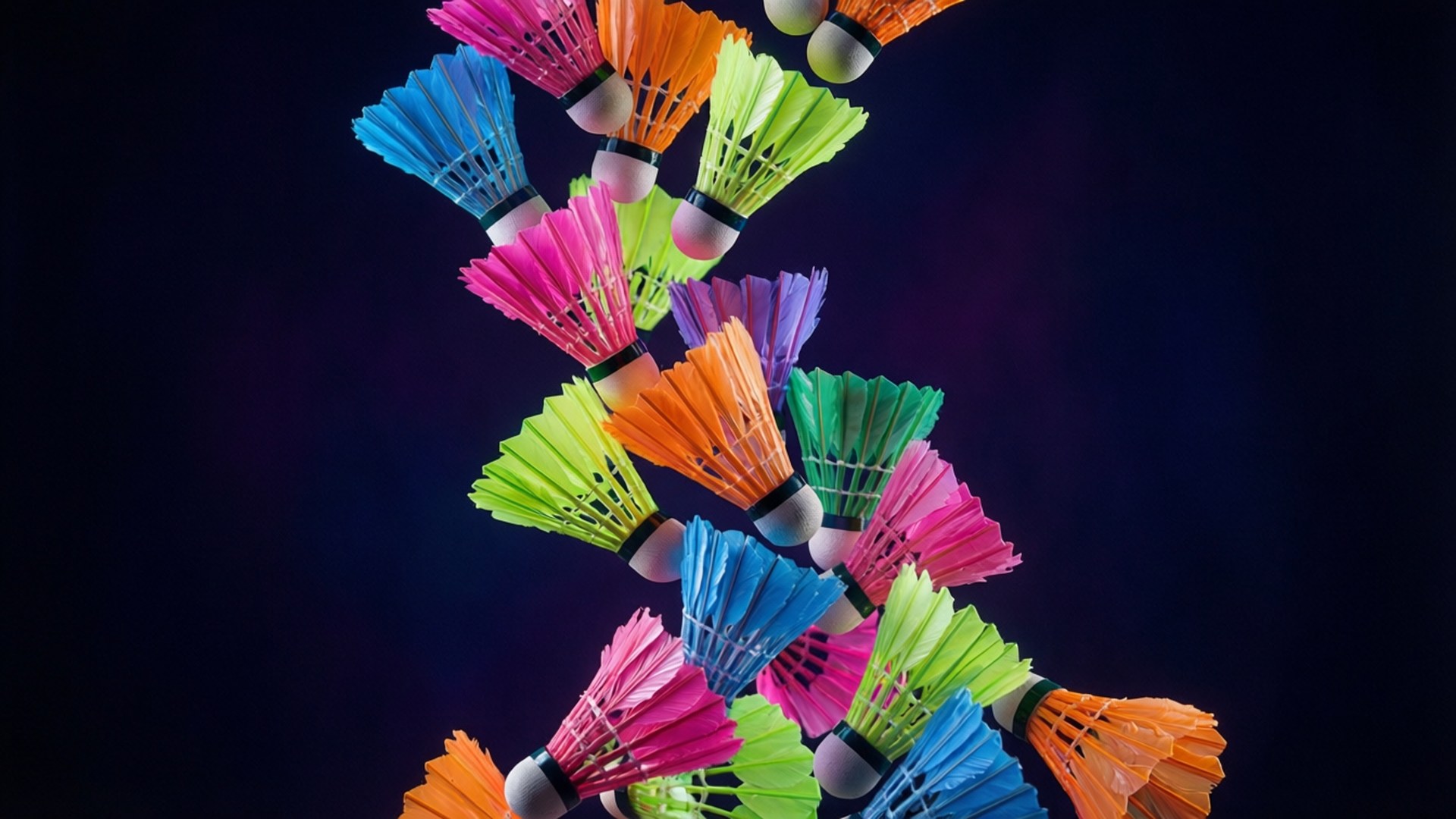Shuttlecock Rain 壁紙 — 鮮豔的霓虹色羽毛球在深色漸變背景上以動態螺旋形式層疊。