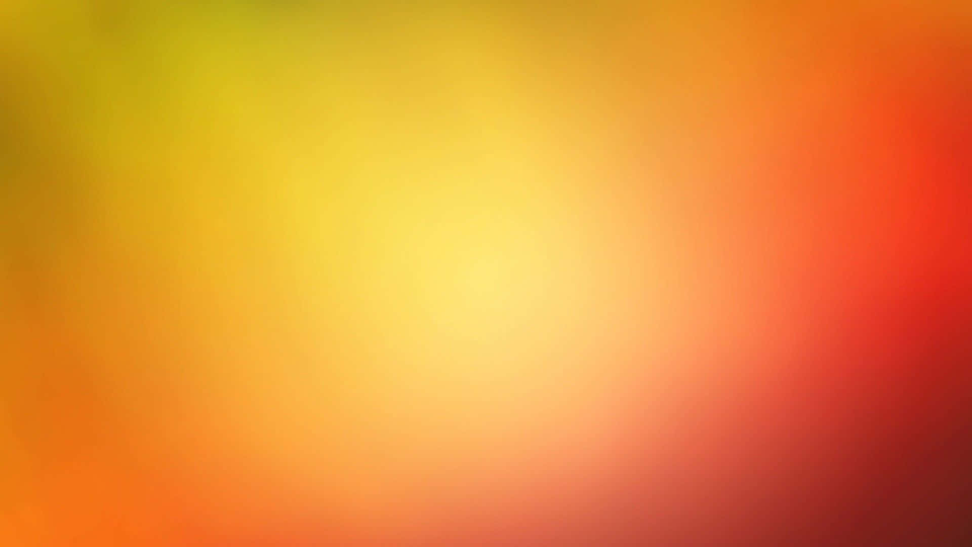 Solid Yellow 桌布 壁紙 — 溫暖的黃色、橙色和紅色色調柔和漸變，無縫融合在整個畫面中。
