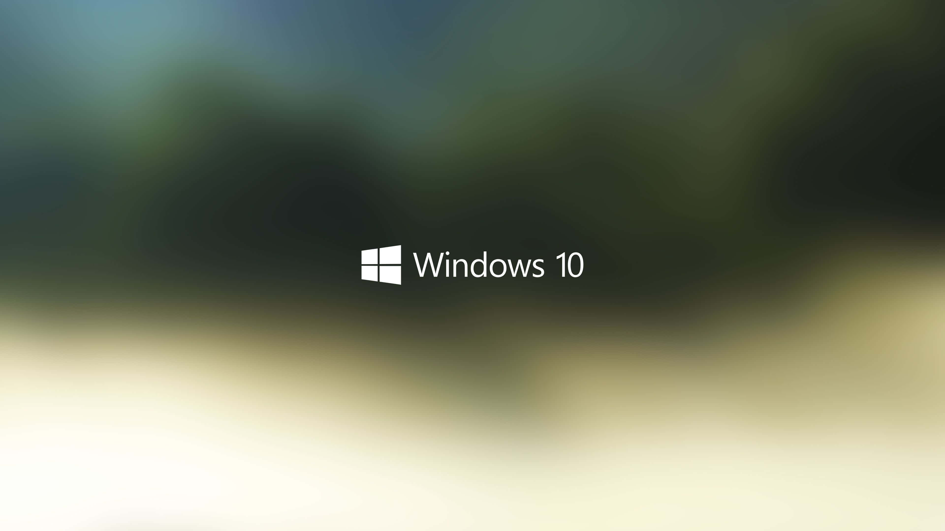 Windows 10 Desktop 桌布 壁紙 — Windows 10 標誌居中於模糊的漸變背景上，顏色為青綠色和米色。