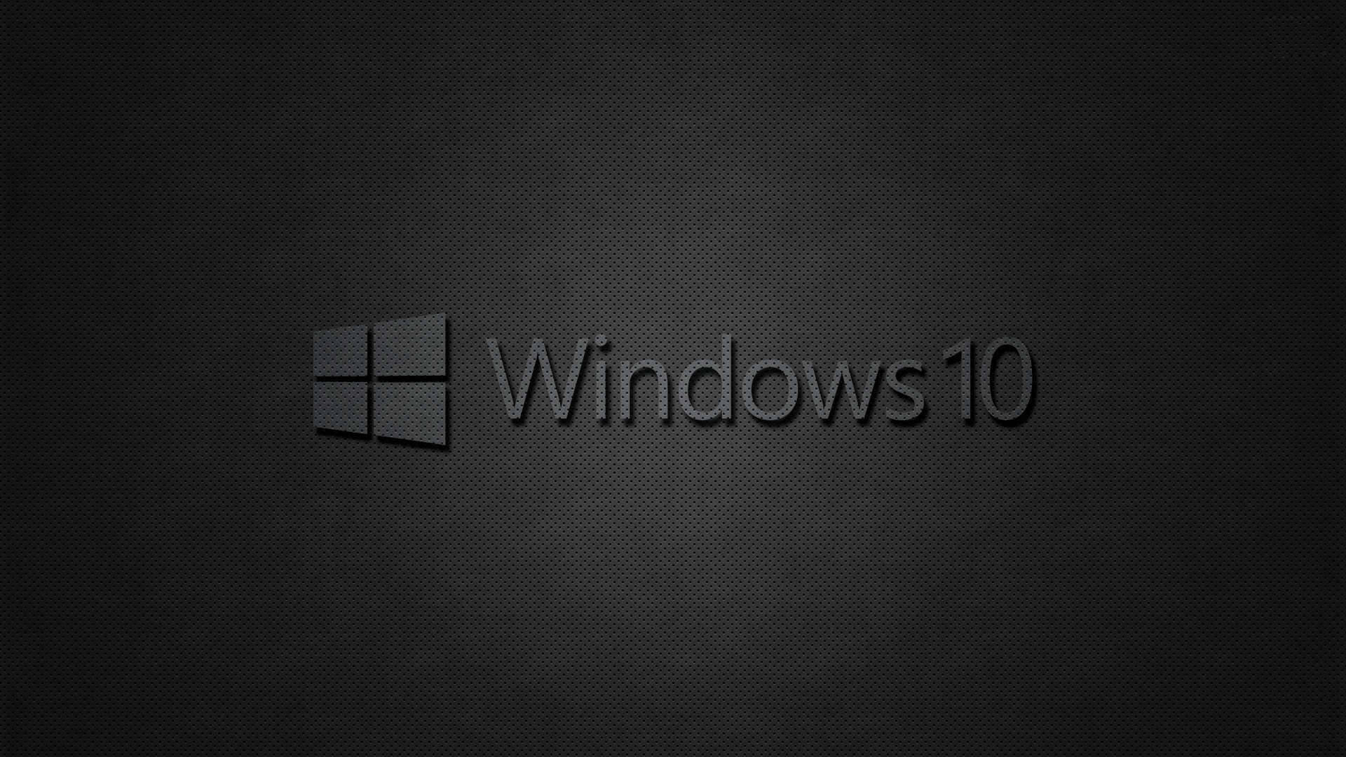 黑色 Windows 10 桌布 壁紙 — Windows 10 標誌居中於深色紋理背景上，帶有微妙的漸變照明。